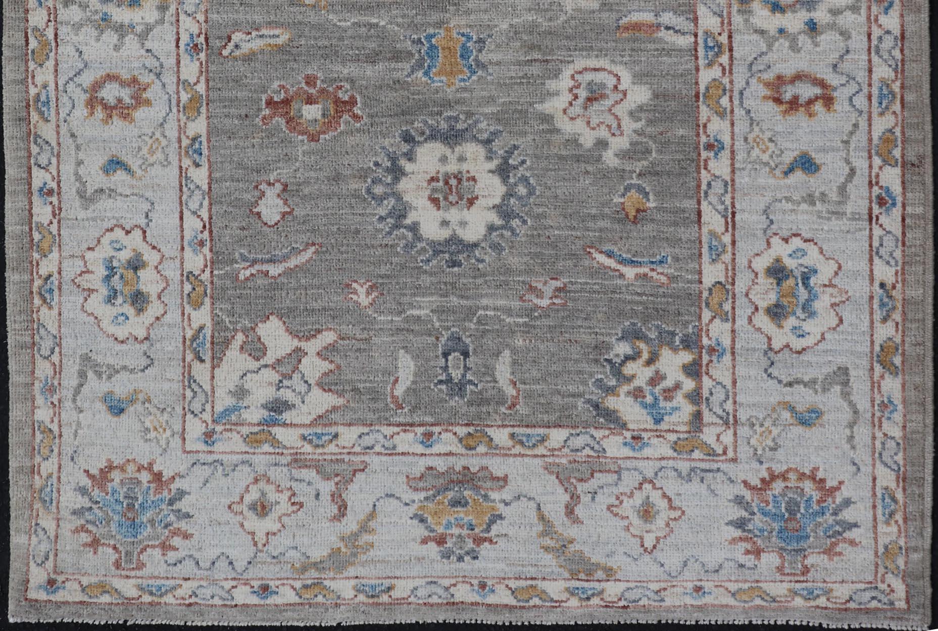 Hand-Knotted Floral Designed Oushak with Muted Background with Earthy Tones and Soft Blue For Sale