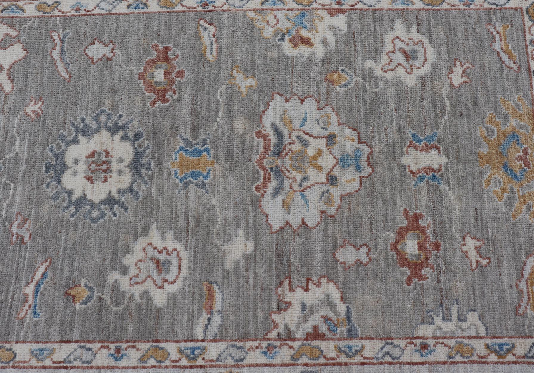 Contemporary Floral Designed Oushak with Muted Background with Earthy Tones and Soft Blue For Sale