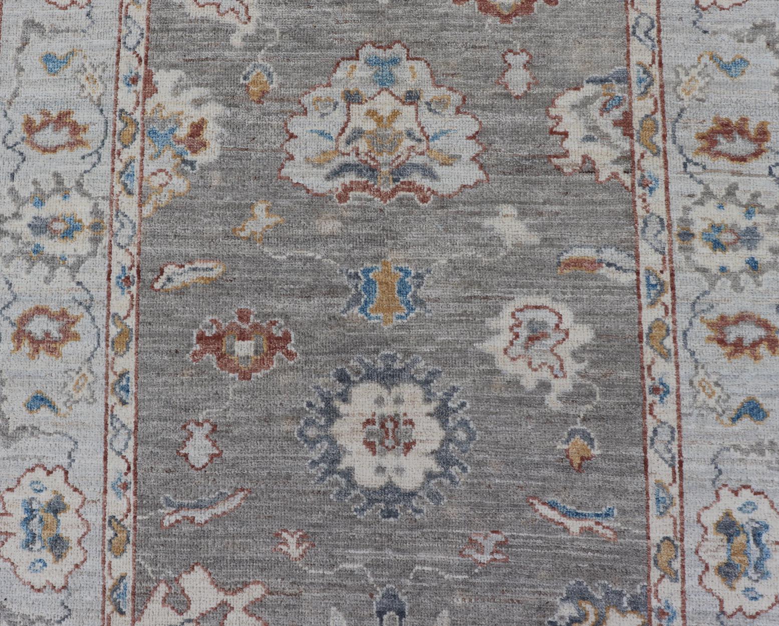 Wool Floral Designed Oushak with Muted Background with Earthy Tones and Soft Blue For Sale