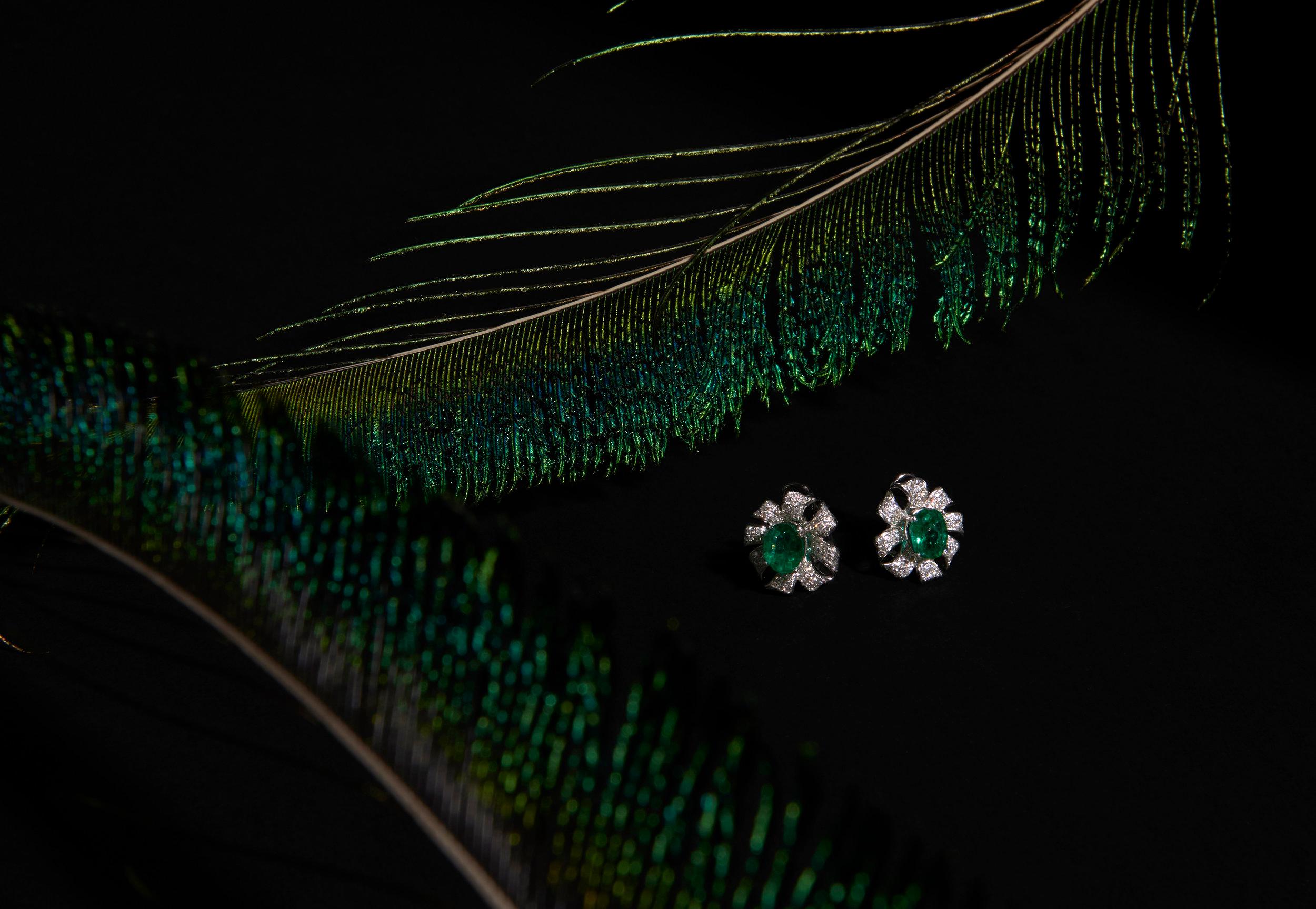 Stunning Emeralds set in a Floral Design with pave brilliant cut Diamonds in 18k White Gold.