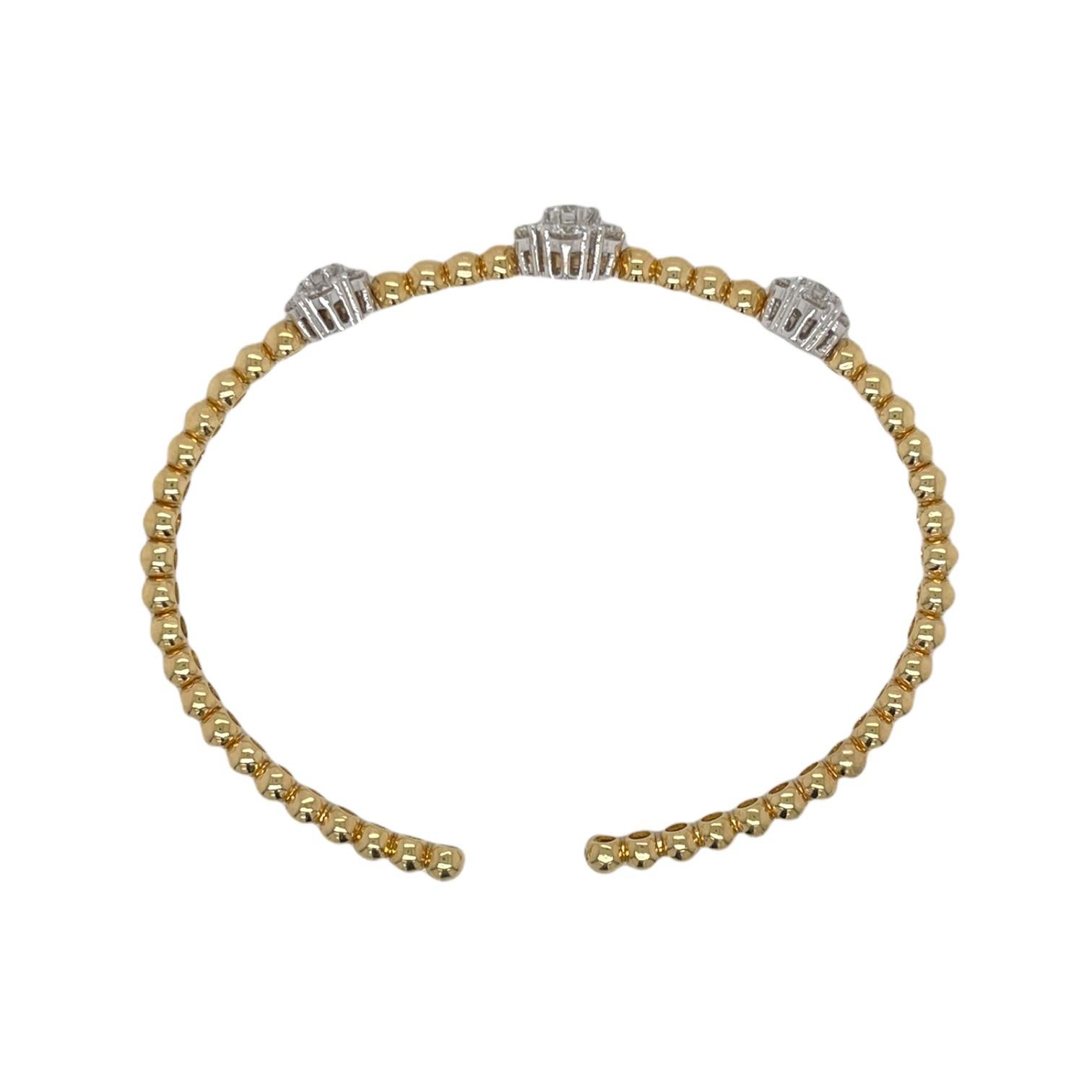 One ladies floral diamond cluster flexible bangle bracelet in 18k yellow and white gold. Bracelet contains 3 floral diamond clusters totaling 21 round brilliant diamonds, 1.88tcw. Diamonds are near colorless and SI1 in clarity. All stones are