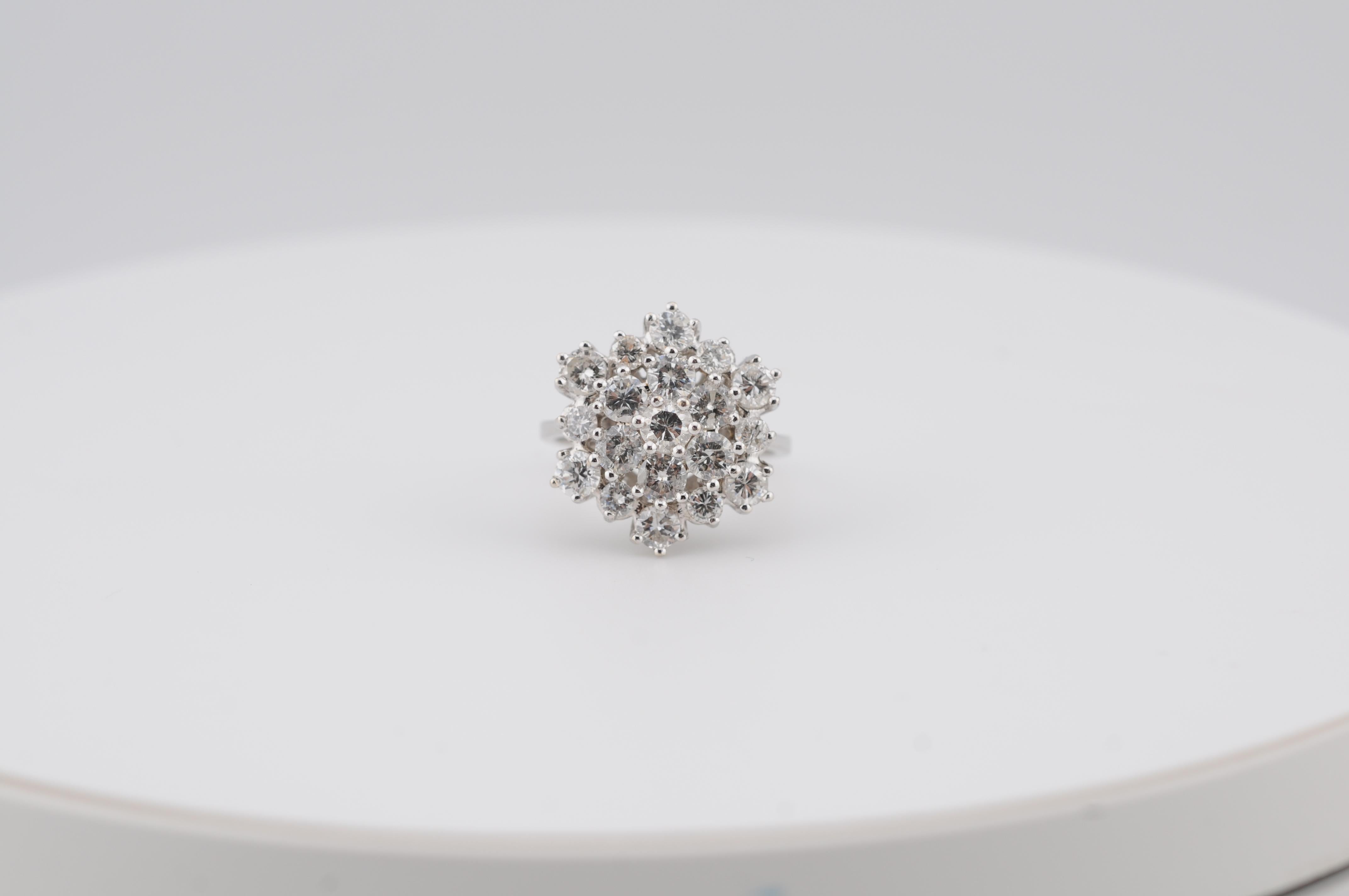 A beautifully designed flower-shaped cluster ring set with 19 brilliant-cut diamonds totaling 2.49 carats. The diamonds range from VVS1 to VS2 clarity and F–H color, displaying exceptional brilliance and fire.

Crafted in solid 14K white gold, the