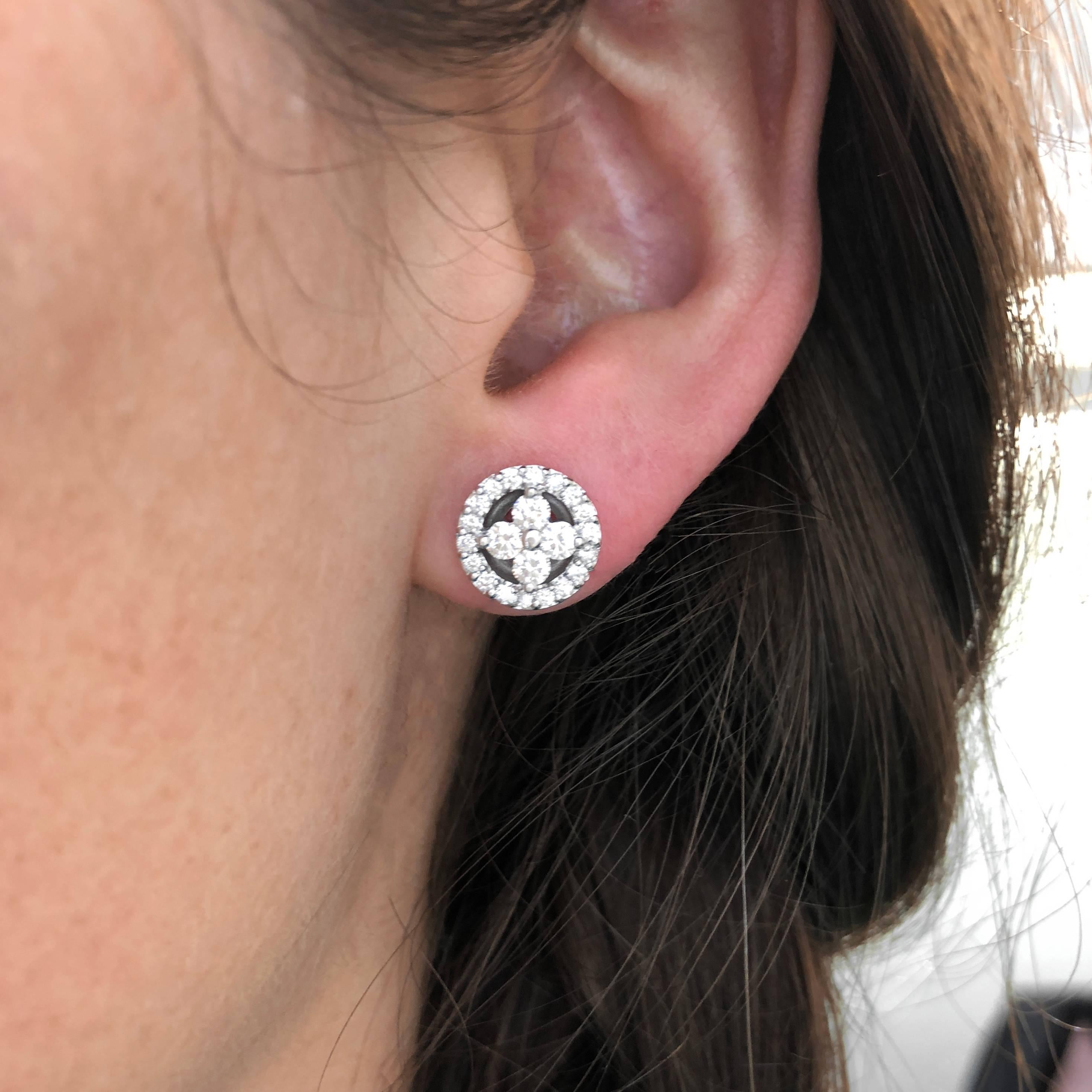 A lovely and dainty pair of 18k white gold and diamond earrings in a floral target design. Earrings measure approx. 10.5mm in diameter and are set with approx. 1.00 carat total of pave diamonds. Earrings are pierced and secure with posts and tension