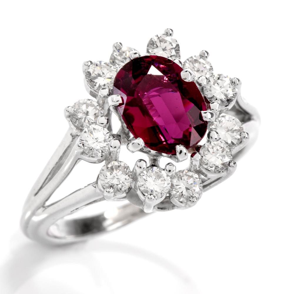 This stunning lady Diana style diamond and ruby cocktail ring is crafted in 18-karat white gold. Showcasing a prominent GIA lab reported prong-set oval shaped all natural ruby weighing approx. 1.45 carats. Surrounded by a halo of 12 round-cut