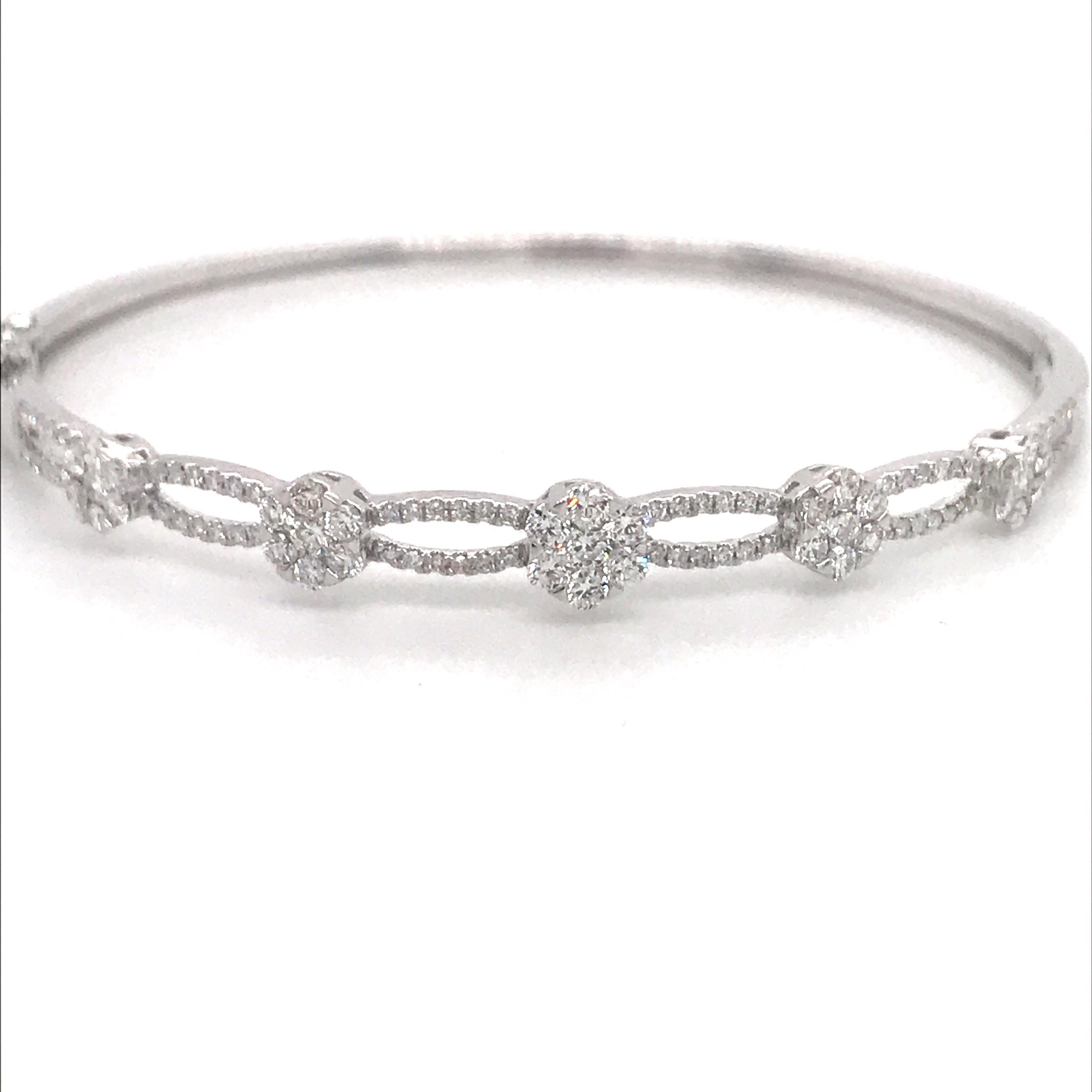18K White gold bangle featuring graduated diamond floral & swirl design weighing 1.24 carats.
Color G-H
Clarity SI