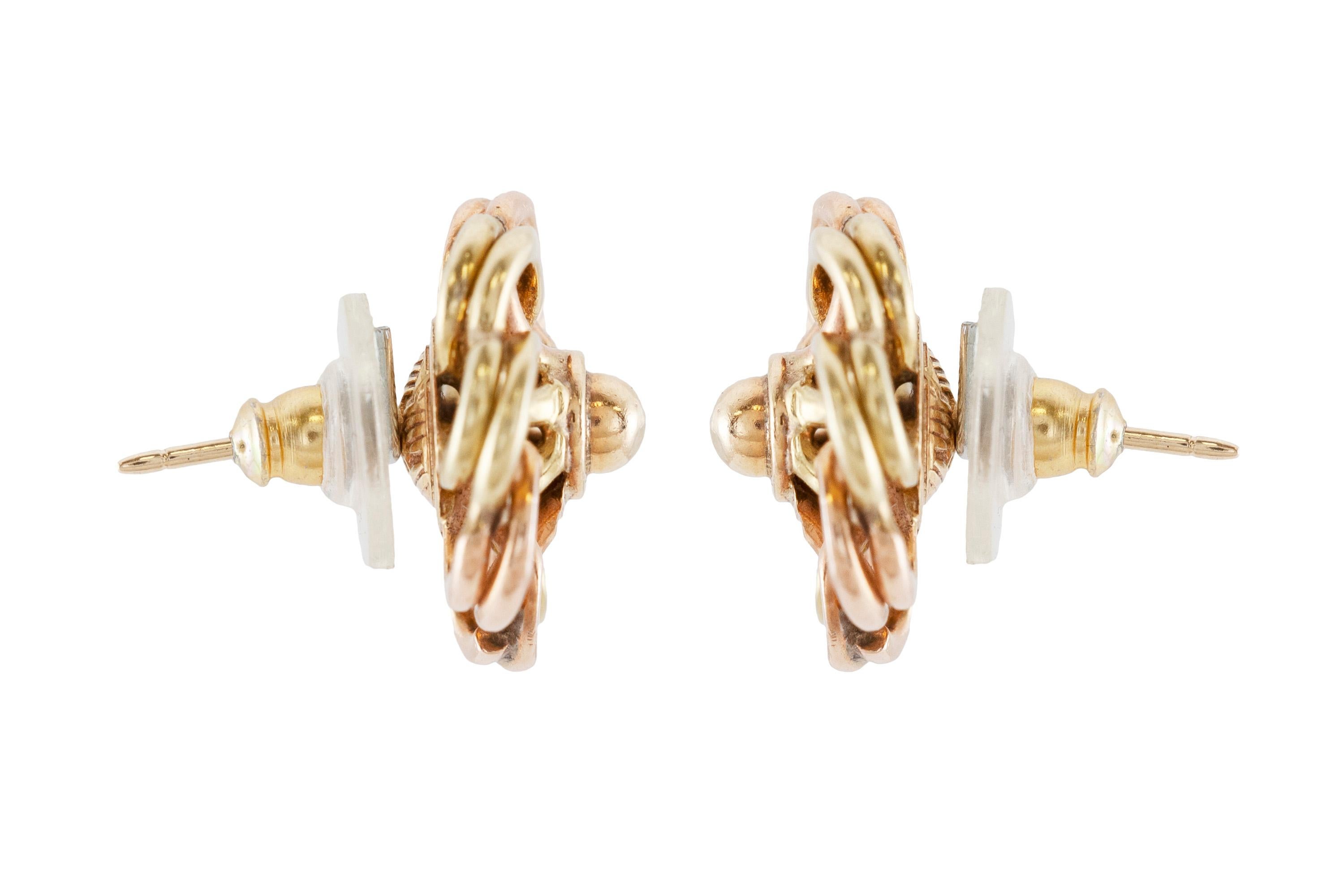The earrings are finely crafted in 14k yellow and rose gold, weighing 8.1 dwt. 
Circa 1940.