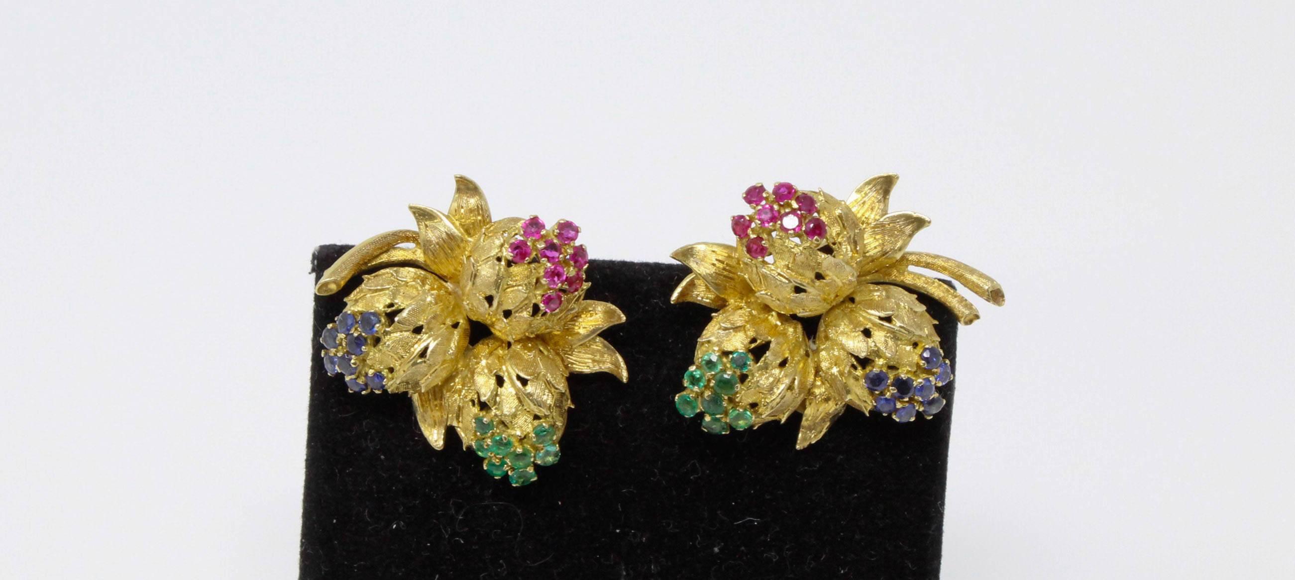 Sapphire, ruby, and emerald floral earring set in 18 karat yellow gold.