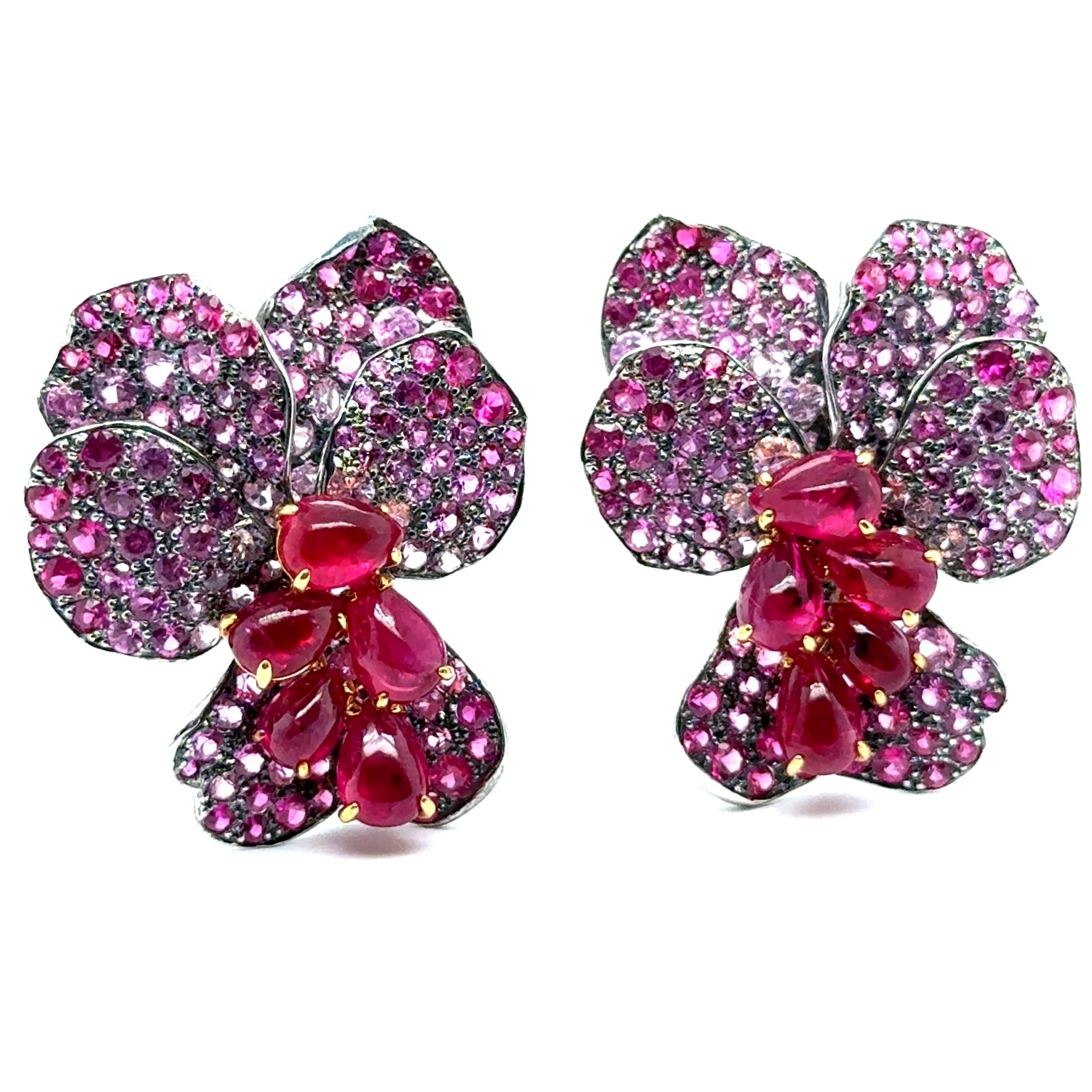 Step into the magic of distant Amazonian forests with these extraordinary floral earrings by Laura Munder.

Both delicate blooms are crafted in 18-karat white gold, adorned with the fiery brilliance of 10 rubies weighing 8.00 carats and the soft