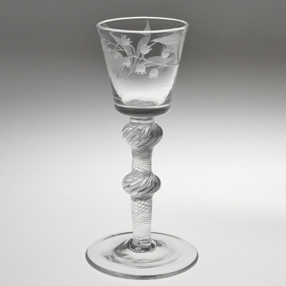 Heading : Floral Engarved Bucket Bowl  Air Twist Wine Glass
Period : George II - c1750
Origin : England
Colour : Clear
Bowl : Bucket - engraved with Lily of the Valley and Tulips
Stem : Air twist stem with inverted baluster knop and flattened