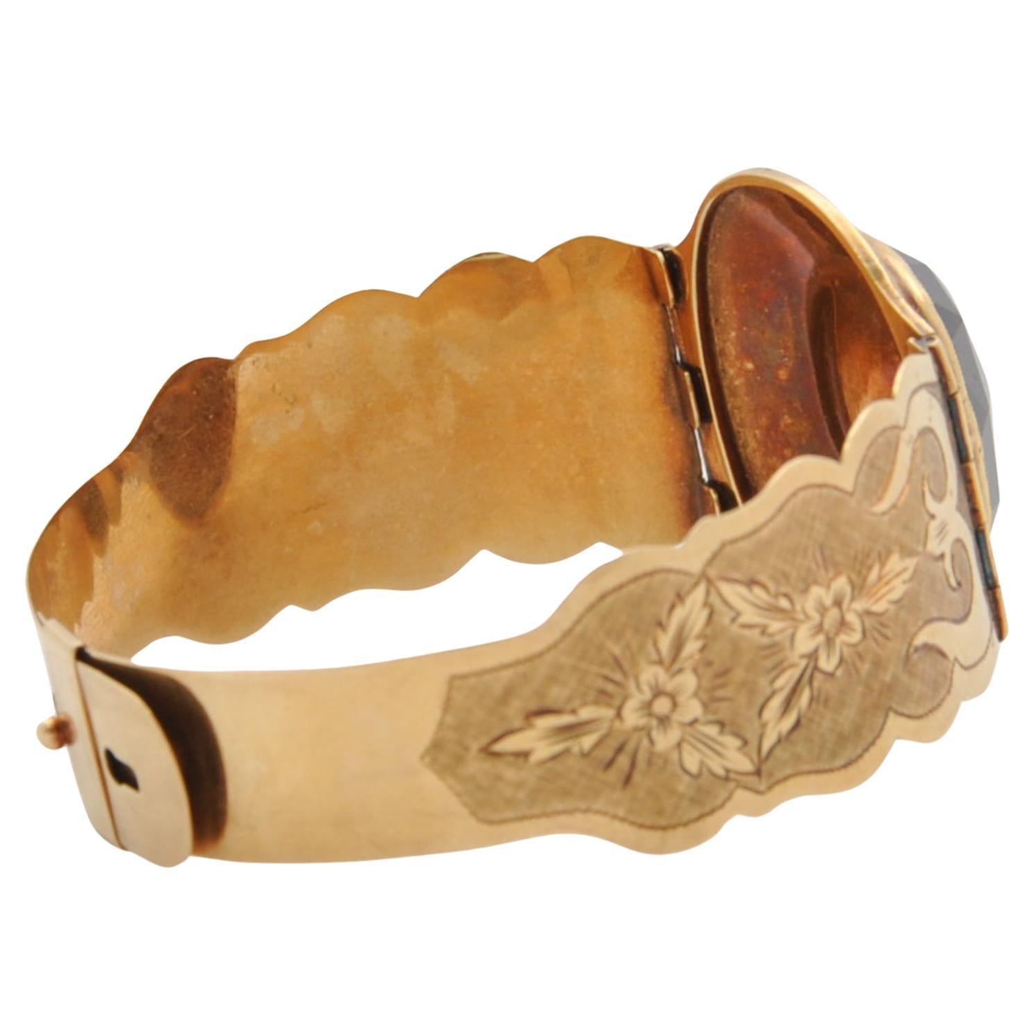 Oval Cut Floral Engraved Gold and Garnet Antique Bracelet For Sale