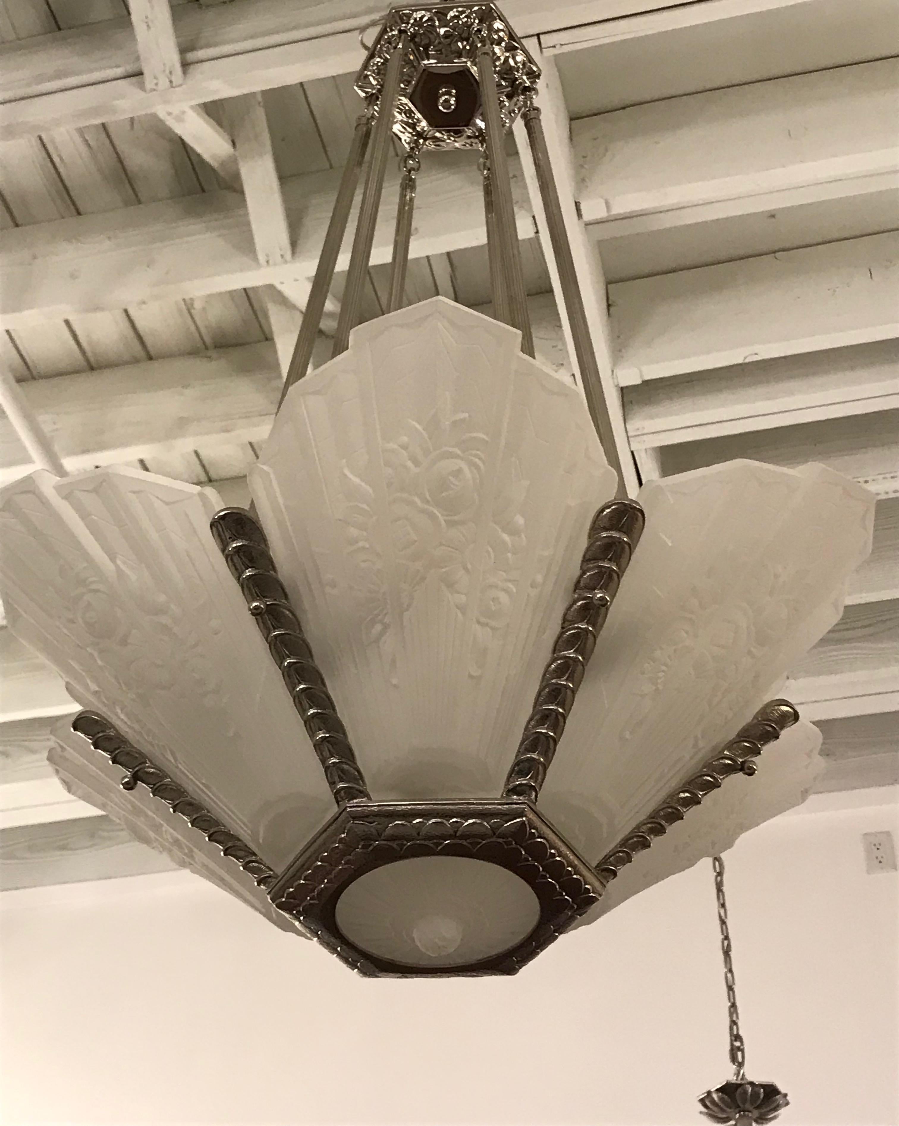 Gorgeous French Art Deco chandelier signed by Des Hanots. With six frosted panels and beautiful center bowl having floral motif. Held by polished nickel geometric design frame. Ceiling cap has beautiful floral design motif. Has been rewired for