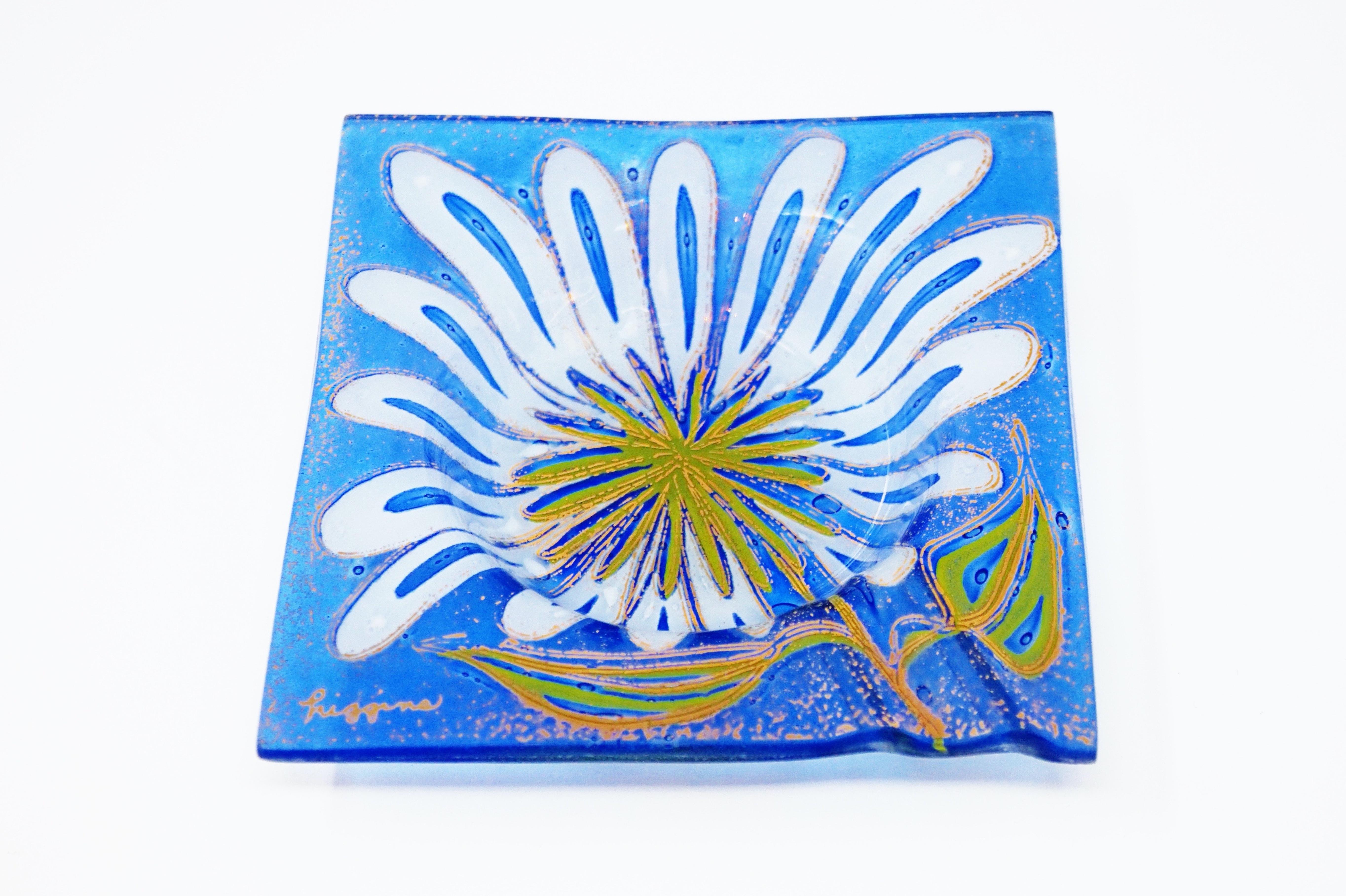 A fused glass ashtray by Michael and Francis Higgins circa 1950s with floral motif. 

Signed “Higgins”

Measures 5