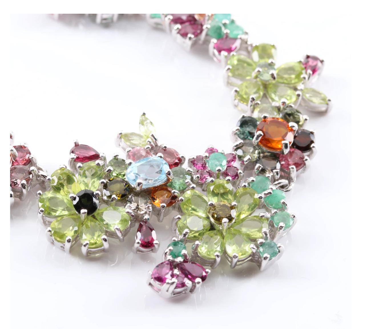 A most Incredibly Charming 34 carat Multi-Gemstone Necklace set in a Masterful Floral Design with 6 carats Tourmalines, 11 carats Peridots, 3.76 carats Garnet, 1.44 carats Sapphire, 1 carat Blue Topaz, 3.3 carats Emerald, 1.56 carats Citrine- 
with