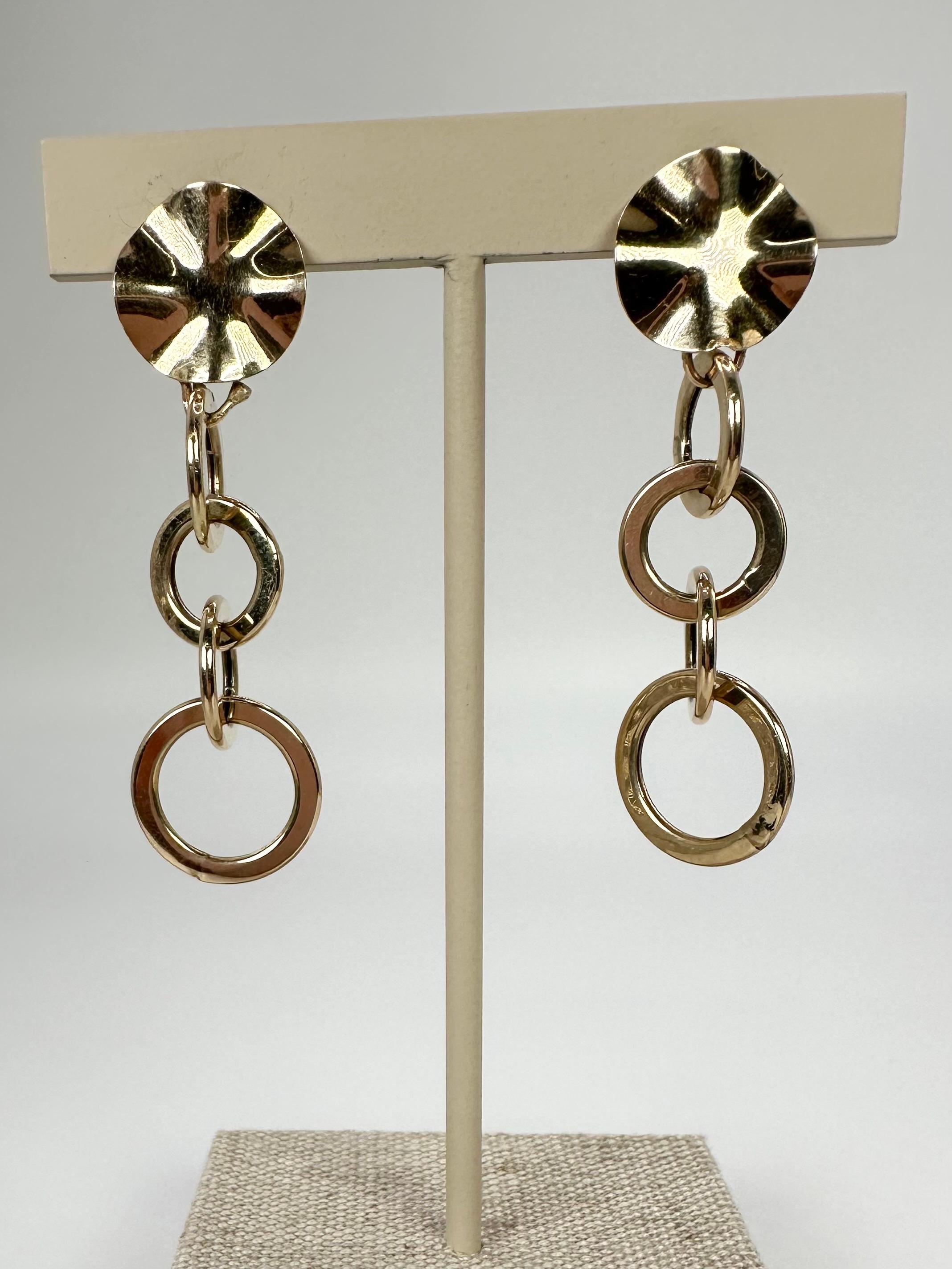 Plain solid gold earrings in floral design in 14KT yellow gold. The earrings are clip-on.
ITEM: AFT 425-00024
GRAM WEIGHT: 5.43gr
GOLD: 14KT gold
WIDTH: 15MM large flower
SIZE: about 3 inches

WHAT YOU GET AT STAMPAR JEWELERS:
Stampar Jewelers,