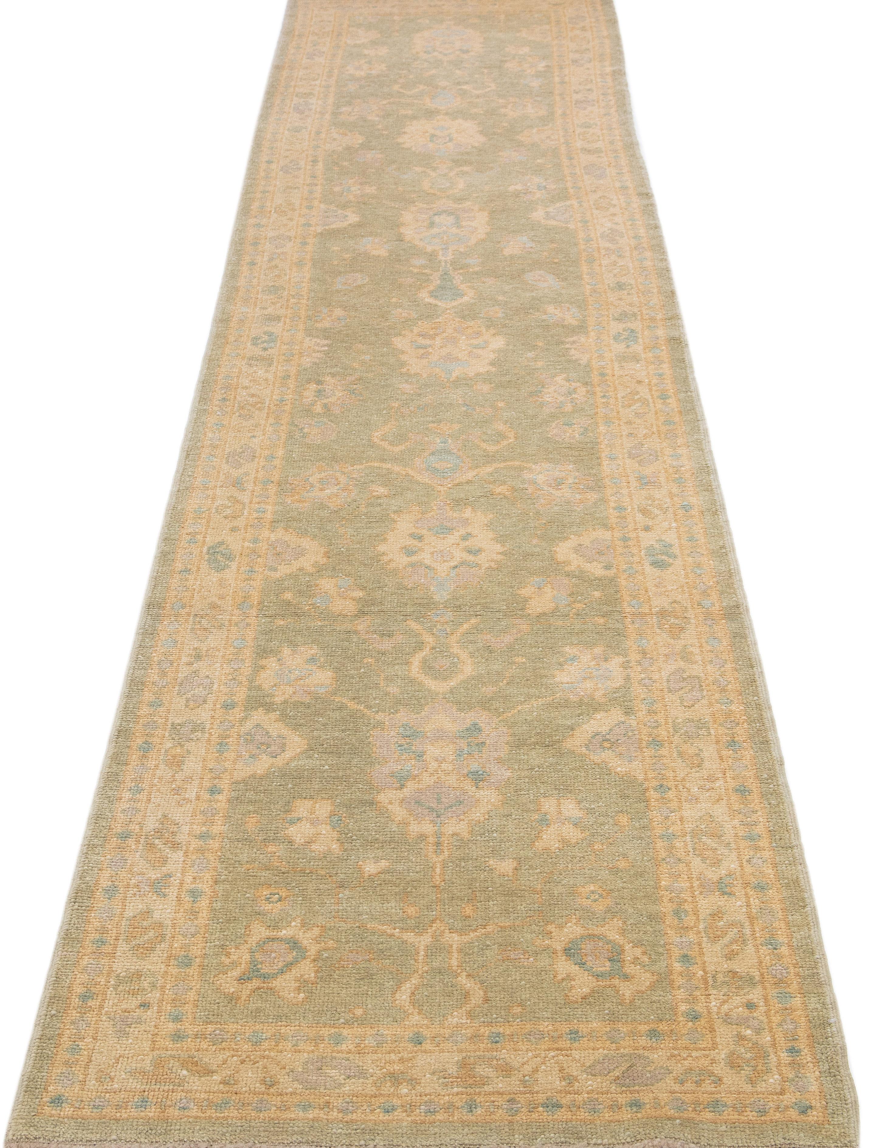 Beautiful Modern Turkish hand-knotted wool rug with a light brown color field. This rug has a designed frame with accent colors of tan and blue in a gorgeous all-over geometric floral design.

This rug measures: 3'1