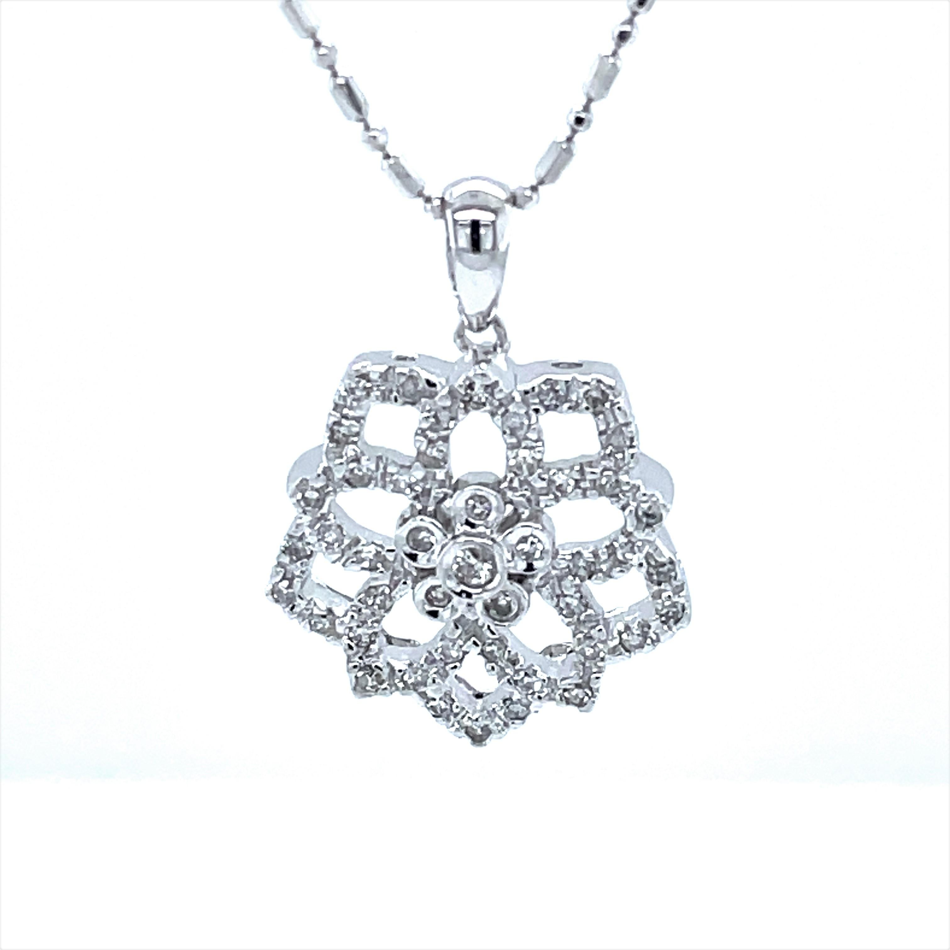 In 14 karat white gold, .22 carats TW of H/ SI round full cut diamonds , 45 stones in total on this pleasing geo floral inspired pendant necklace. Suspended on a fancy 16 inch white gold faceted bead chain that glistens and adds just the right