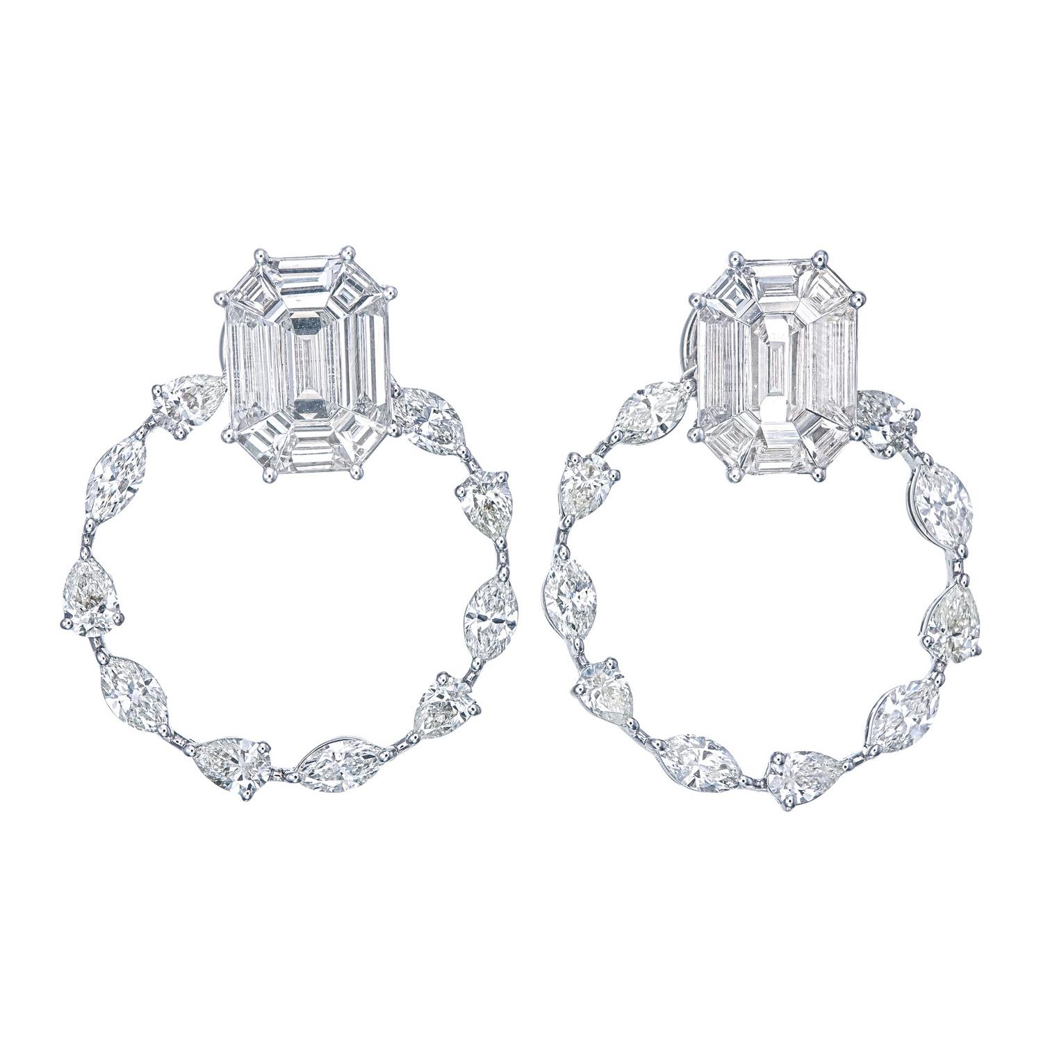 Crafted in 18KT gold, these floral diamond earrings showcase the artistry of invisible setting, where brilliance meets seamless design.
 As a manufacturer of fine jewellery, we create pieces tailored to the refined tastes of discerning clients.
