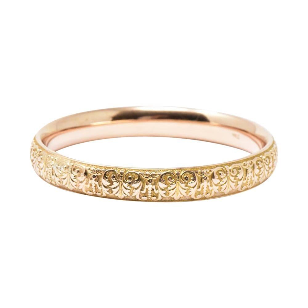 Krementz Art Nouveau Floral 14k Yellow Gold Slip on Bangle. The rich bangle has a floral Nouveau design going the full length of the bangle. Inscribed with the initial F.M.M. There is one small early repair 3 mm. The bracelet is in overall good