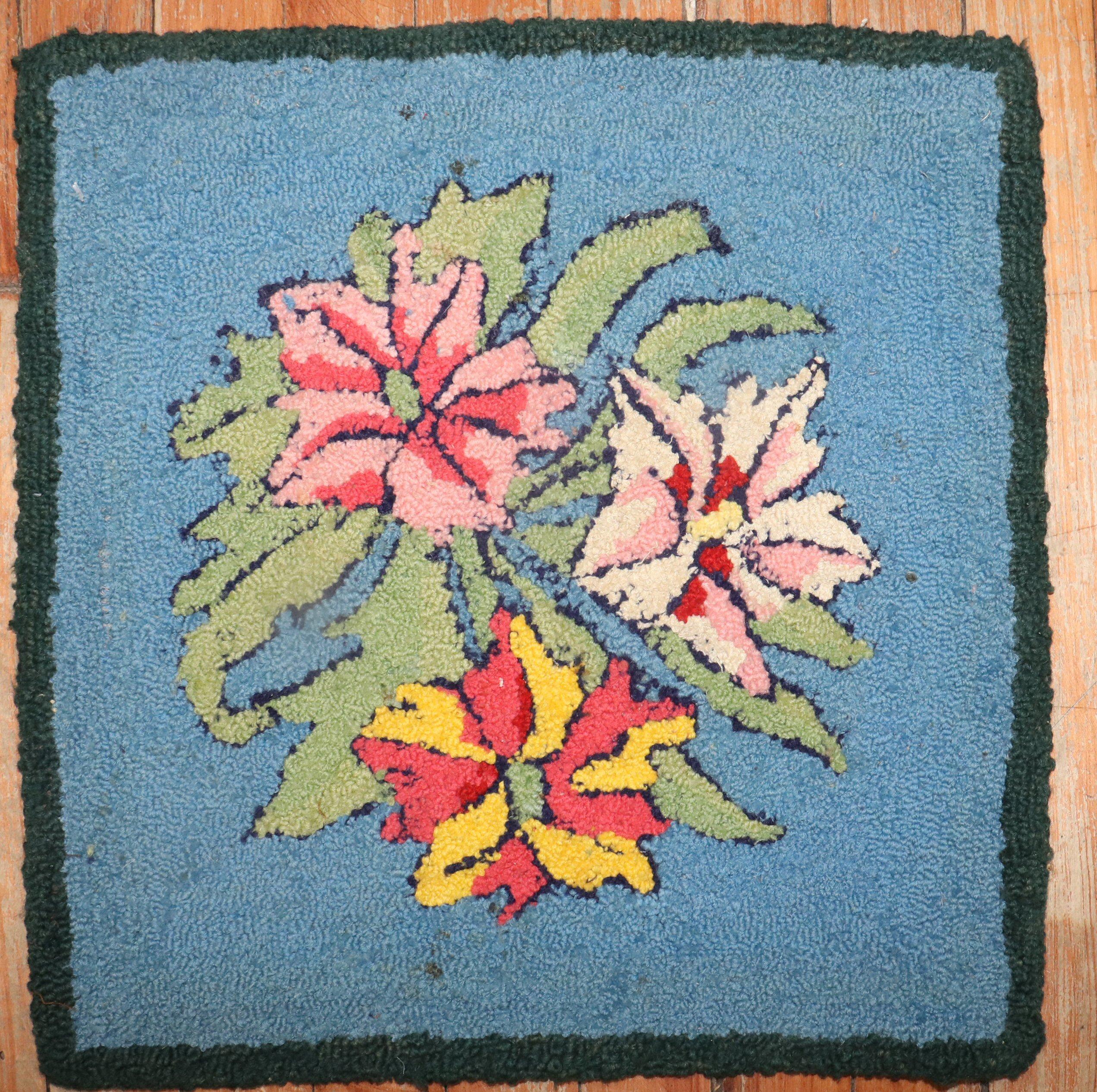 One-of-a-kind American Hooked rug with a floral pattern on a sky blue field.

Measures: 1'5'' x 1'5''.
