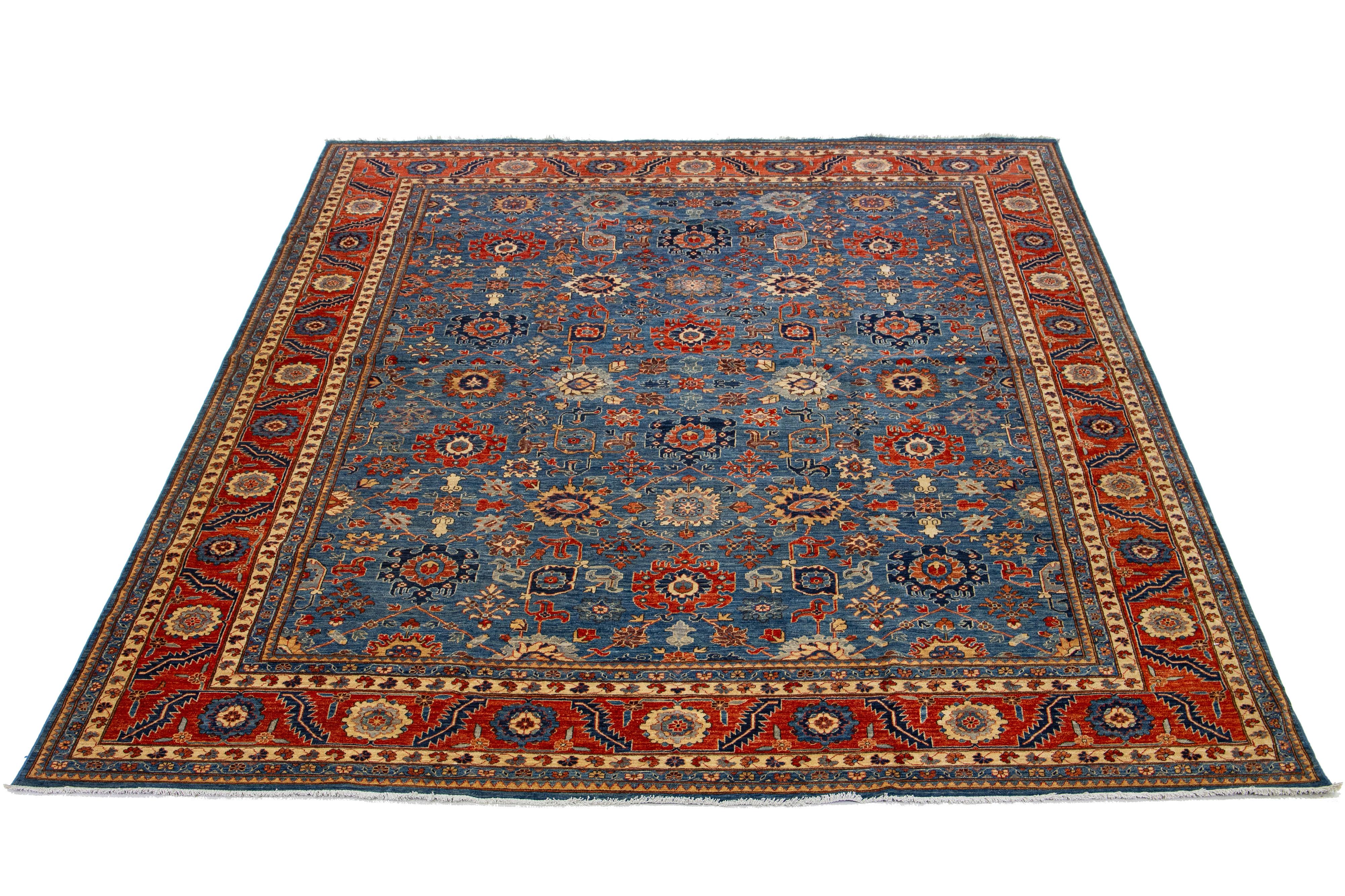 This Serapi-style hand-knotted wool rug features a navy blue color field. The piece showcases a red-designed frame and a breathtaking all-over floral pattern with exquisite multicolor accents.

This rug measures 12'1