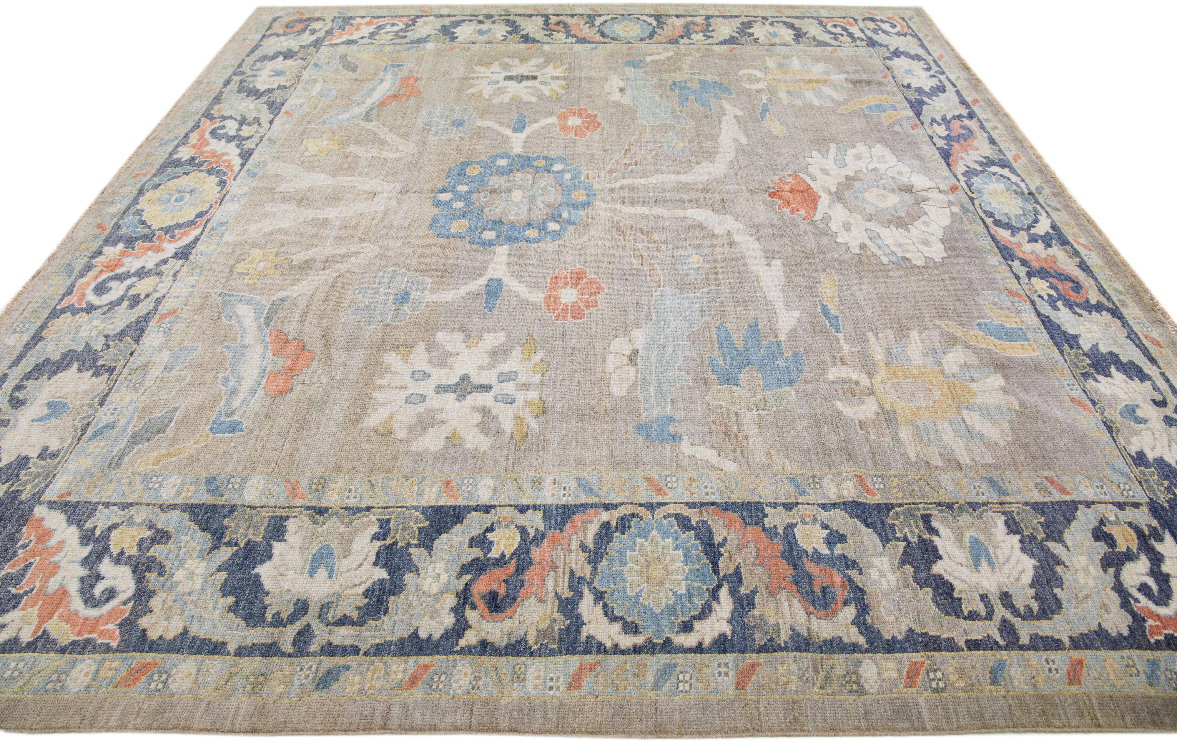 Beautiful modern Sultanabad hand-knotted wool rug with a beige color field. This rug has a navy-blue designed frame with multicolor accents in a gorgeous all-over floral design.

This rug measures: 10'2