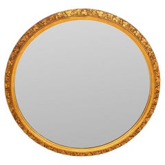 Espejo de pared circular de madera dorada tallada con motivos florales
