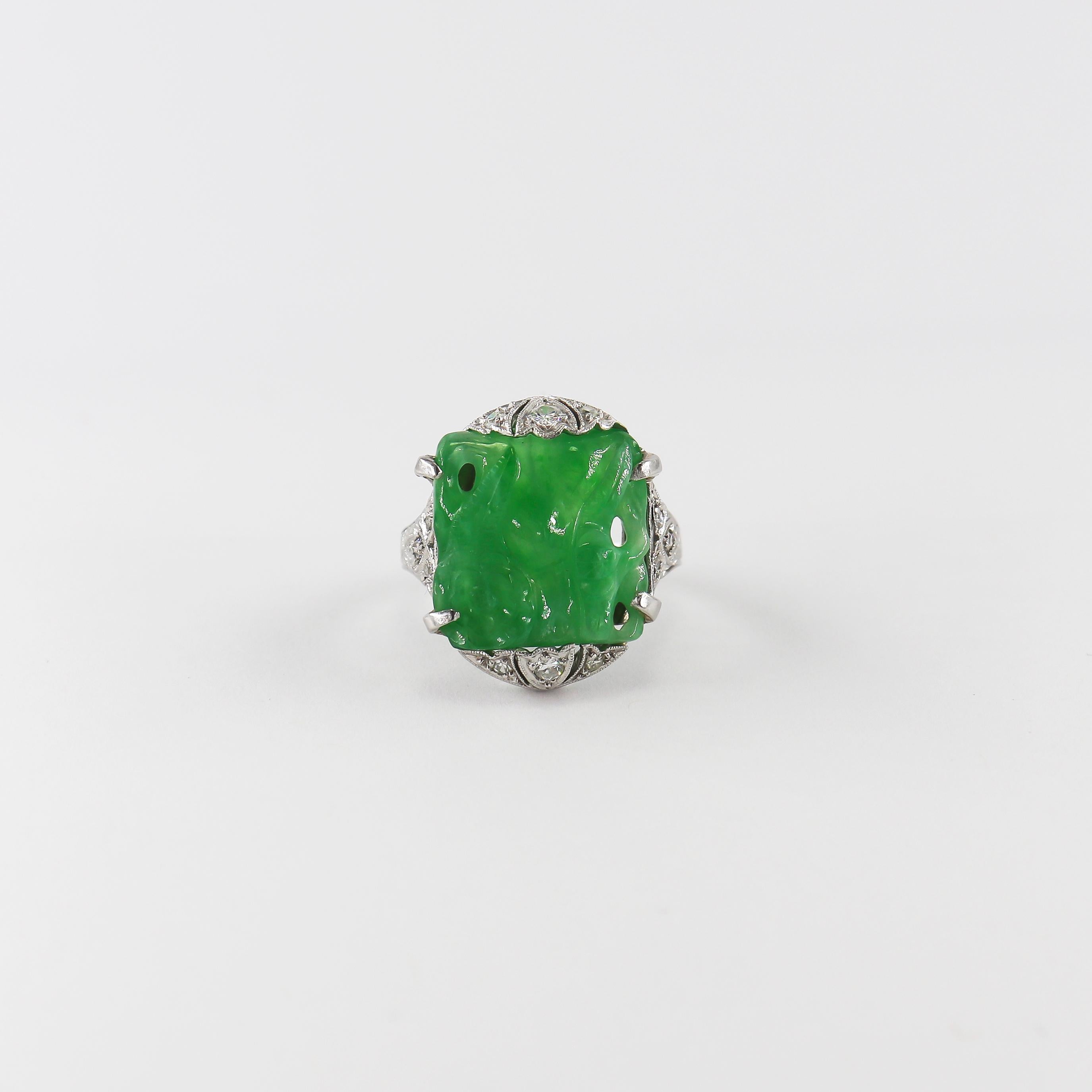 This incredible acquisition by the house of J. Birnbach features a square, carved piece of Jadeite with floral motifs on both the front and back of the stone. Set with assorted antique cut diamonds = approximately 0.20 carat total weight, this piece