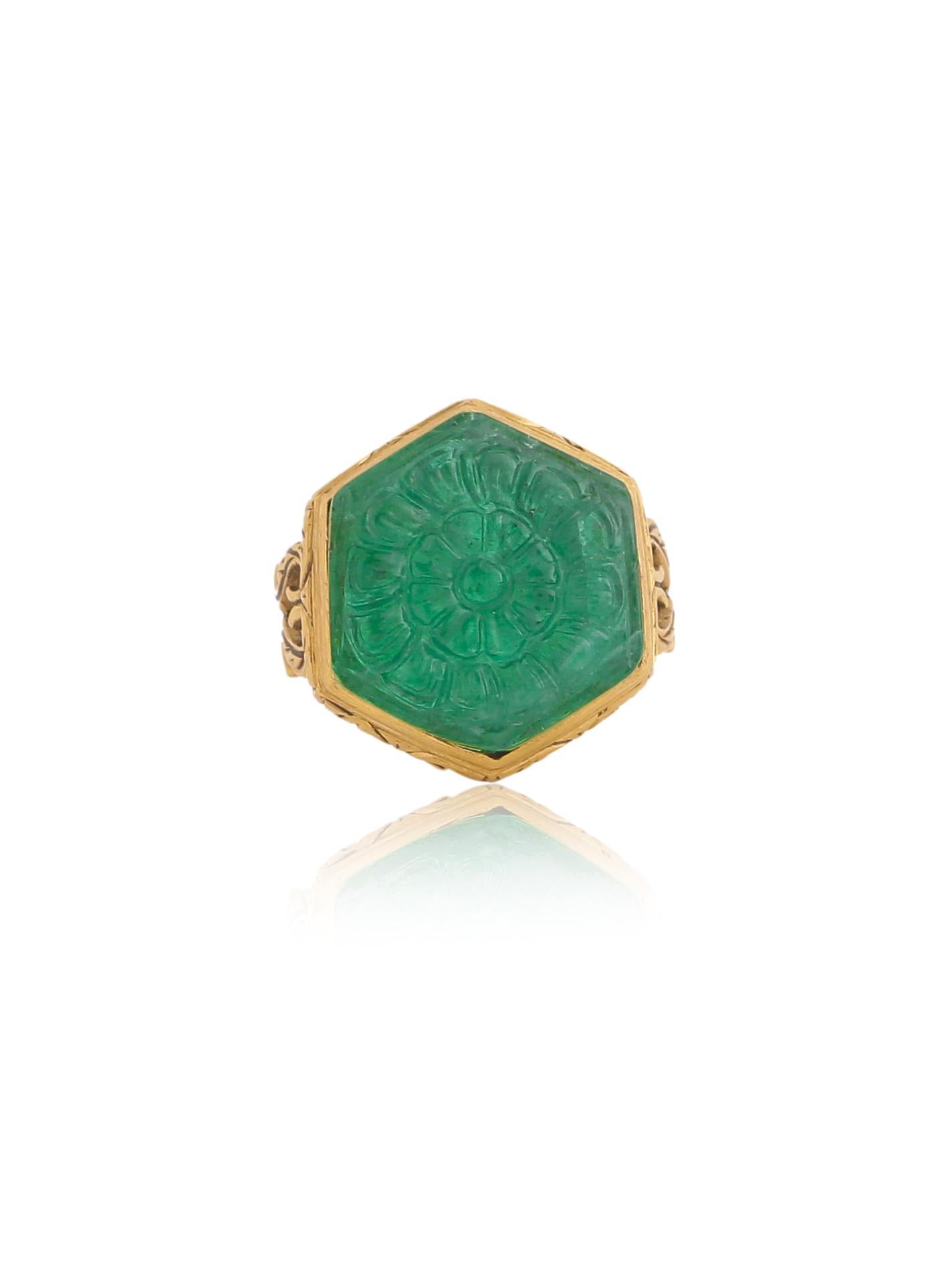 A beautiful Carved Natural Zambian Emerald set in a ring with 18 karat Gold. You will notice really fine intricate work done on gold throughout the ring. The work and the whole piece is handcrafted by our highly trained artisans. The Emerald is