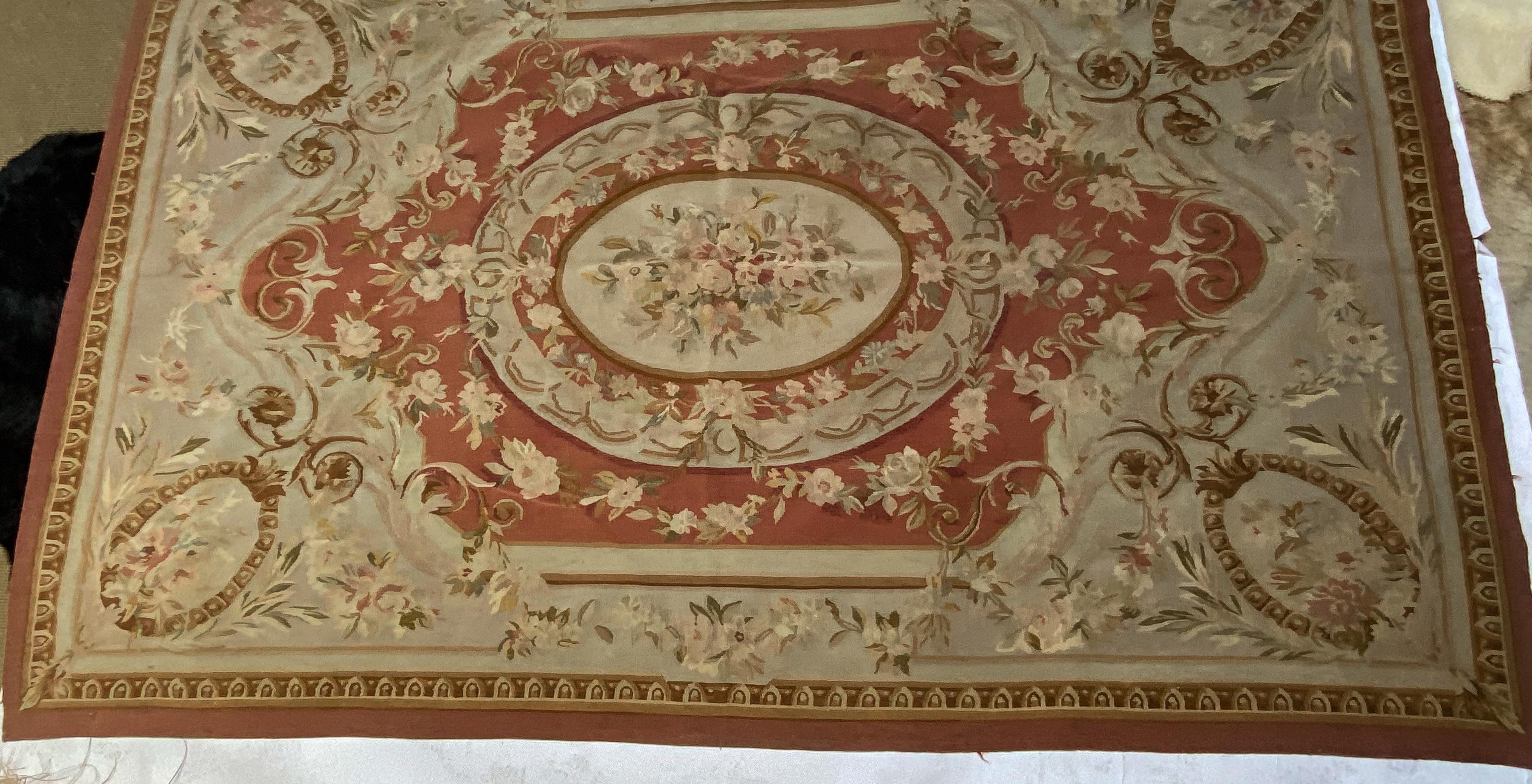 Aubusson rug from the 1960s, traditional style with ocher / burnt orange border and center with floral detail and gold scrolling. 