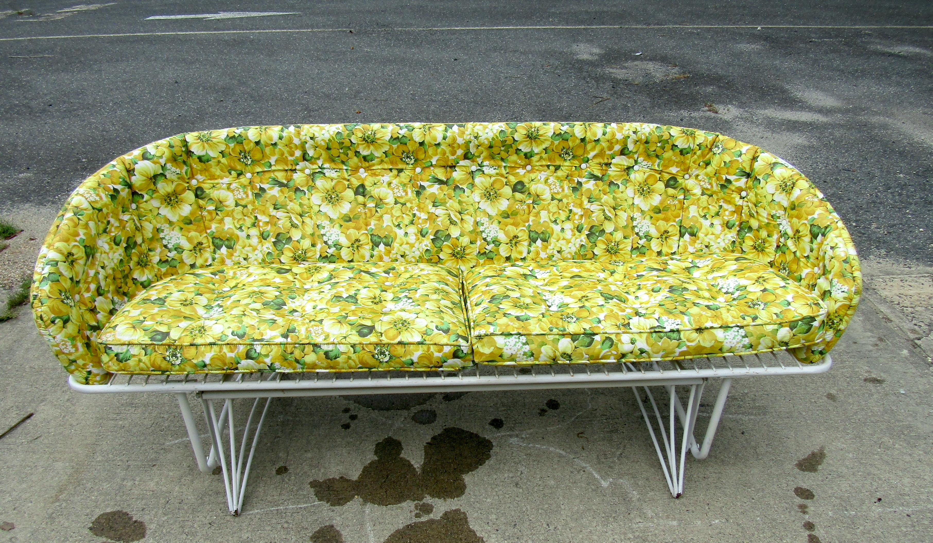 Vintage outdoor patio bench. This bench features an all metal frame with rocking base and floral seat cushions. A simple bench that would be a perfect addition to any outdoor lounge space. Please confirm location NY or NJ.