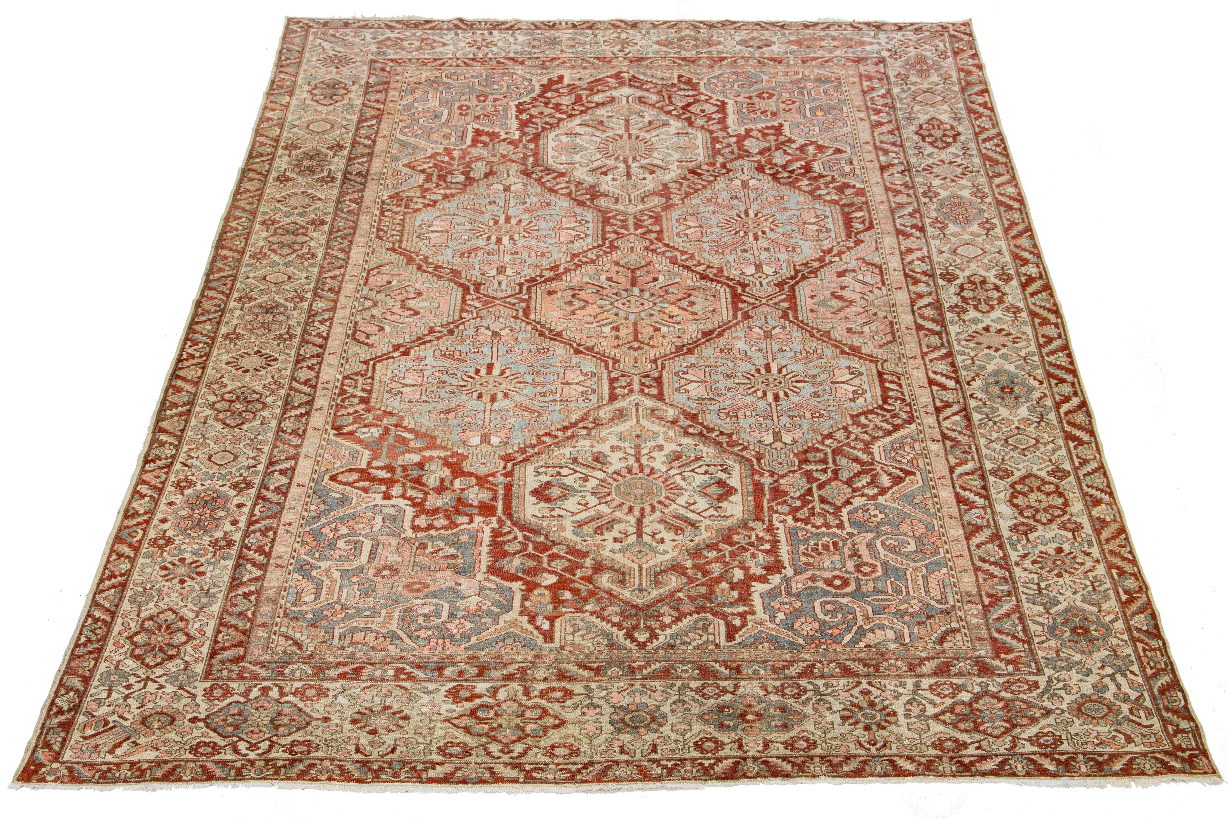 Beautiful Antique Bakhtiari hand-knotted wool rug with a red-rust color field. This Persian piece has a classic blue, beige, and pink Tribal floral design.

This rug measures 11'8