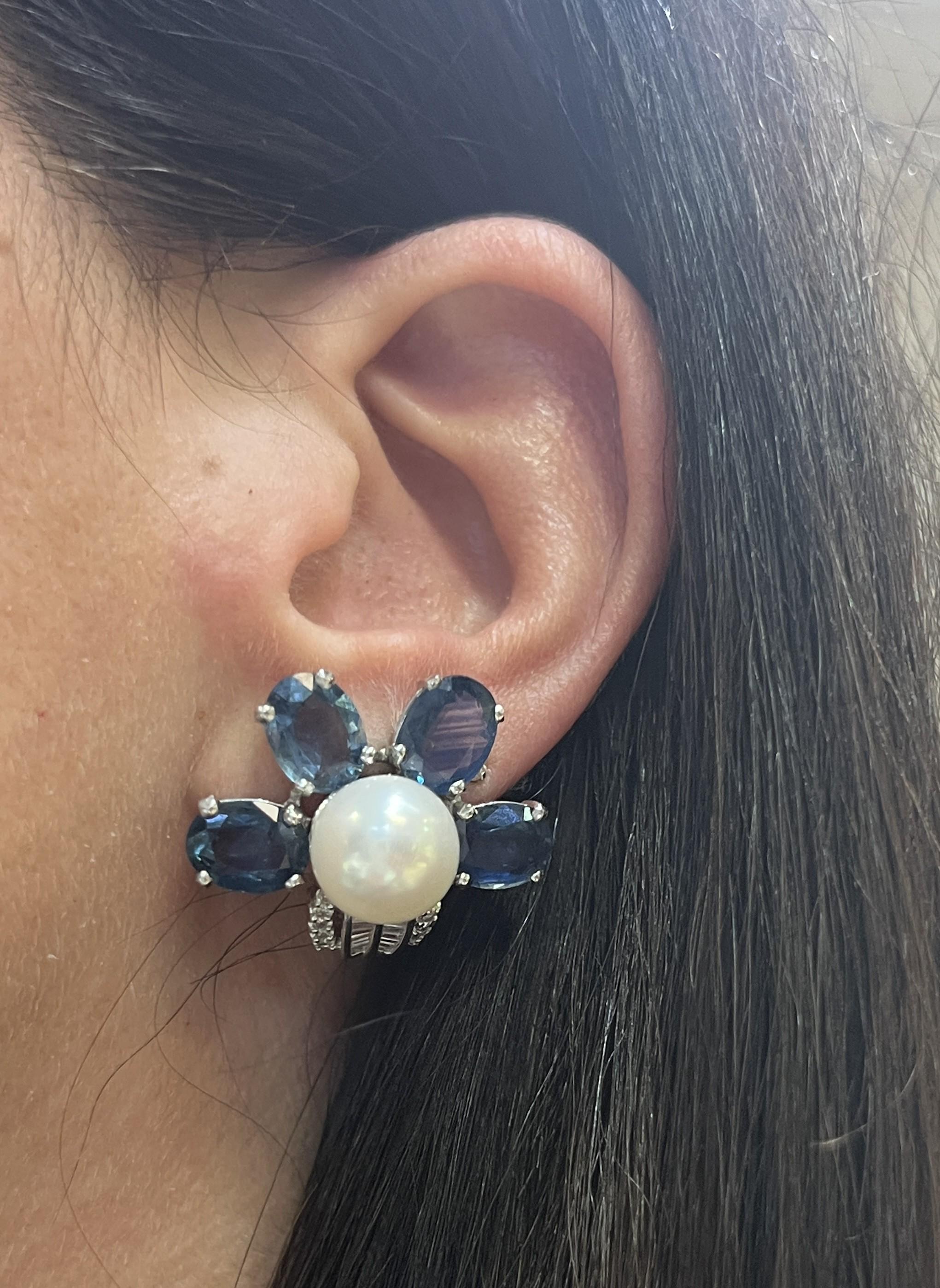 Floral Sapphire and Pearl Earrings 

A pair of white gold floral motif earrings set with cultured pearls and oval-cut sapphires

Approximate Length: 1