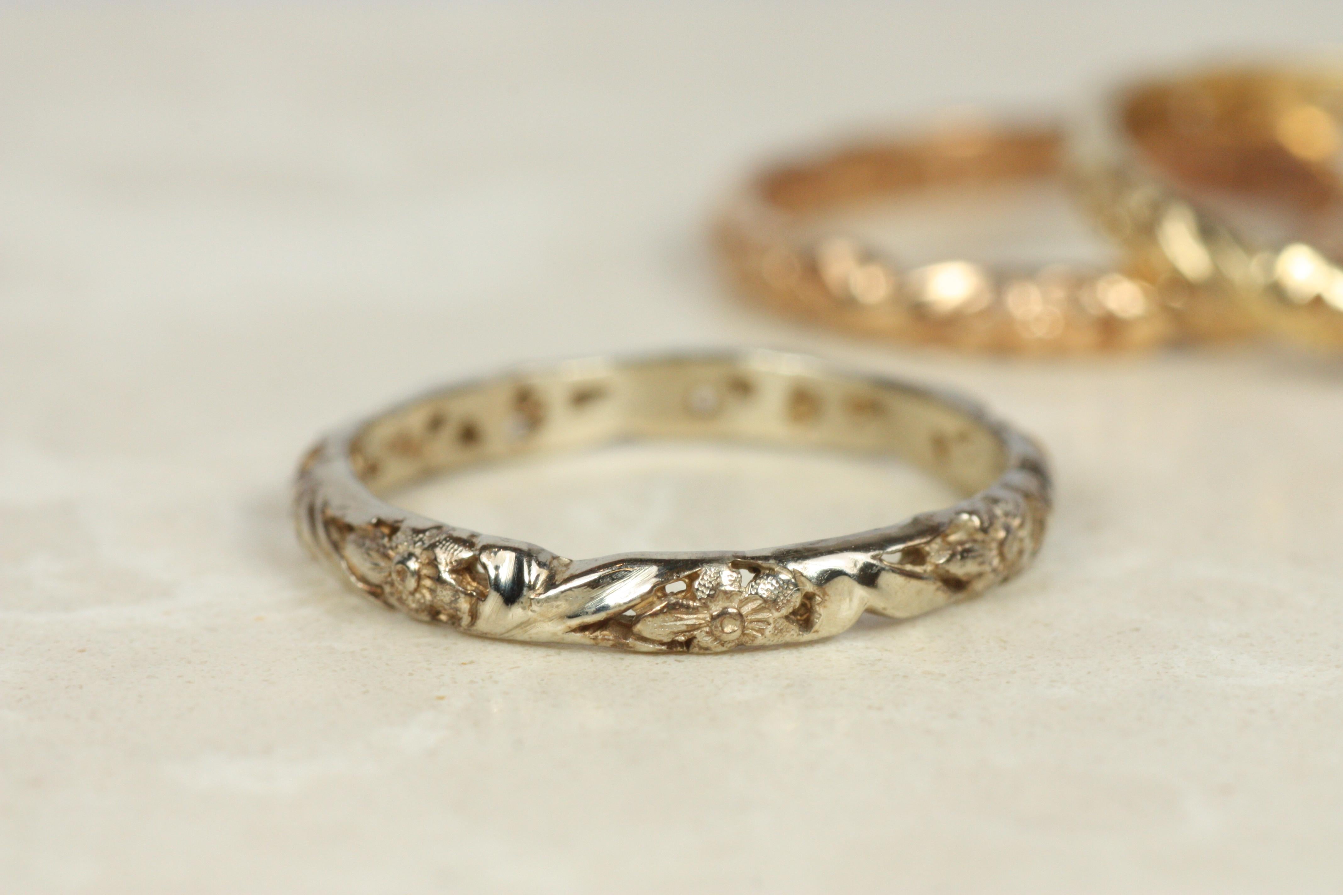 Crafted by Bracken Jewelers in Santa Monica, California. This 14K yellow gold wedding band features a sculpted floral pattern. It is a vintage-inspired design. Stacks beautifully next to an engagement ring with a plain band or one that boasts a