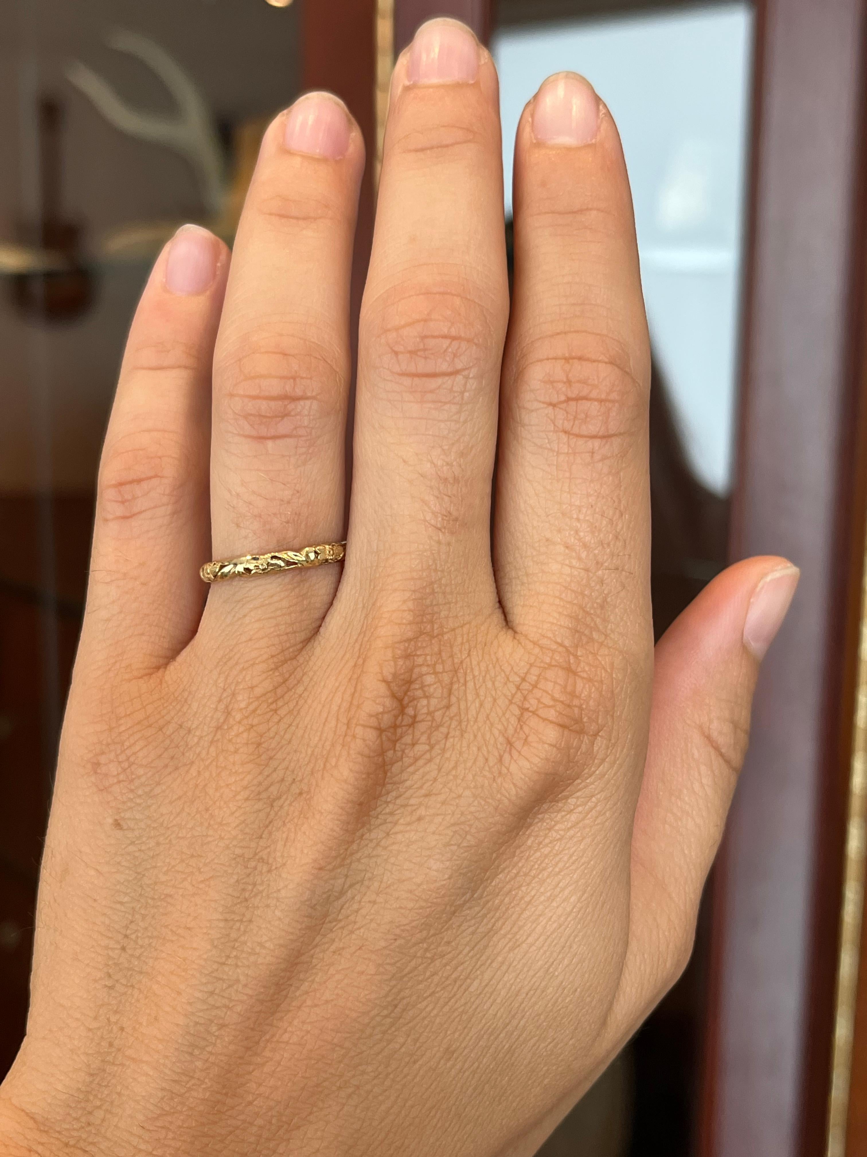 Crafted by Bracken Jewelers in Santa Monica, California. This 14K yellow gold wedding band features a sculpted floral pattern. It is a vintage-inspired design. Stacks beautifully next to an engagement ring with a plain band or one that boasts a