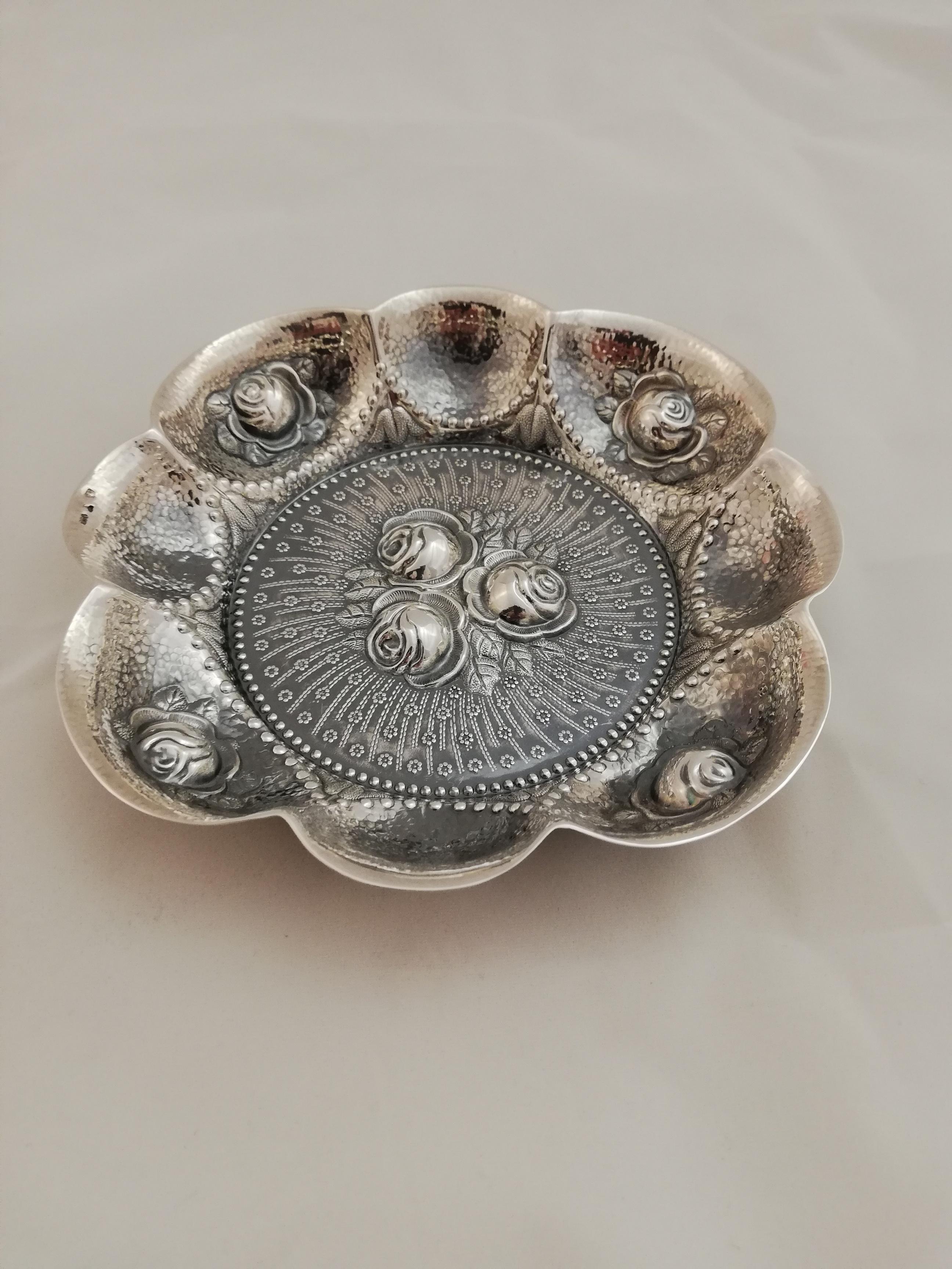 Handmade, chiselled silver dish with flower ornaments. It could be used for various purposed, either as s small serving dish, for appetizers or simply as a decorative object.
 