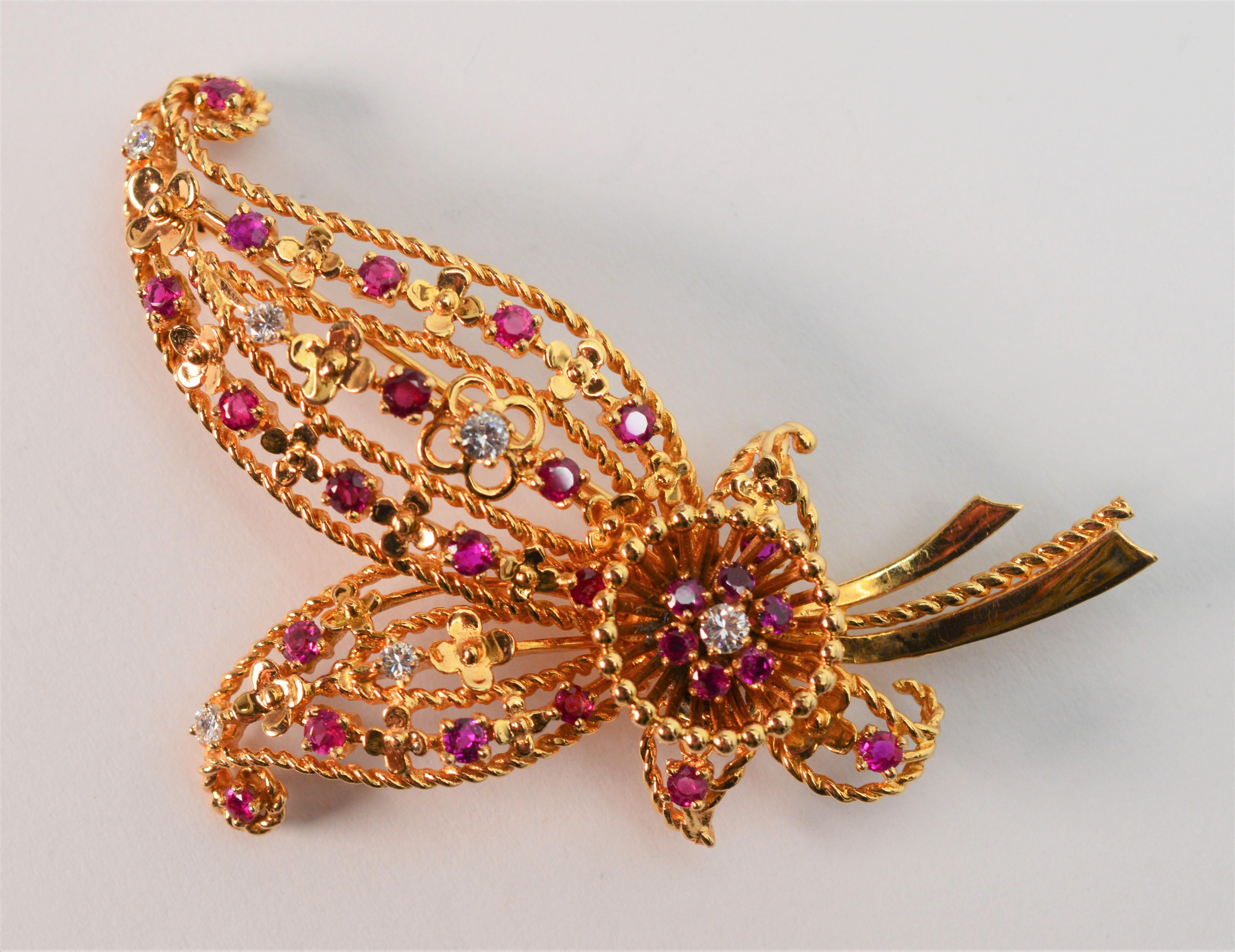 Bright and cheerful describes this colorful finely crafted 2-1/2 inch brooch that is the perfect accessory to accent a lapel or hat.  Swirls of textured 14K gold filigree in a bouquet inspired shape are hosts for the multiple round faceted ruby and