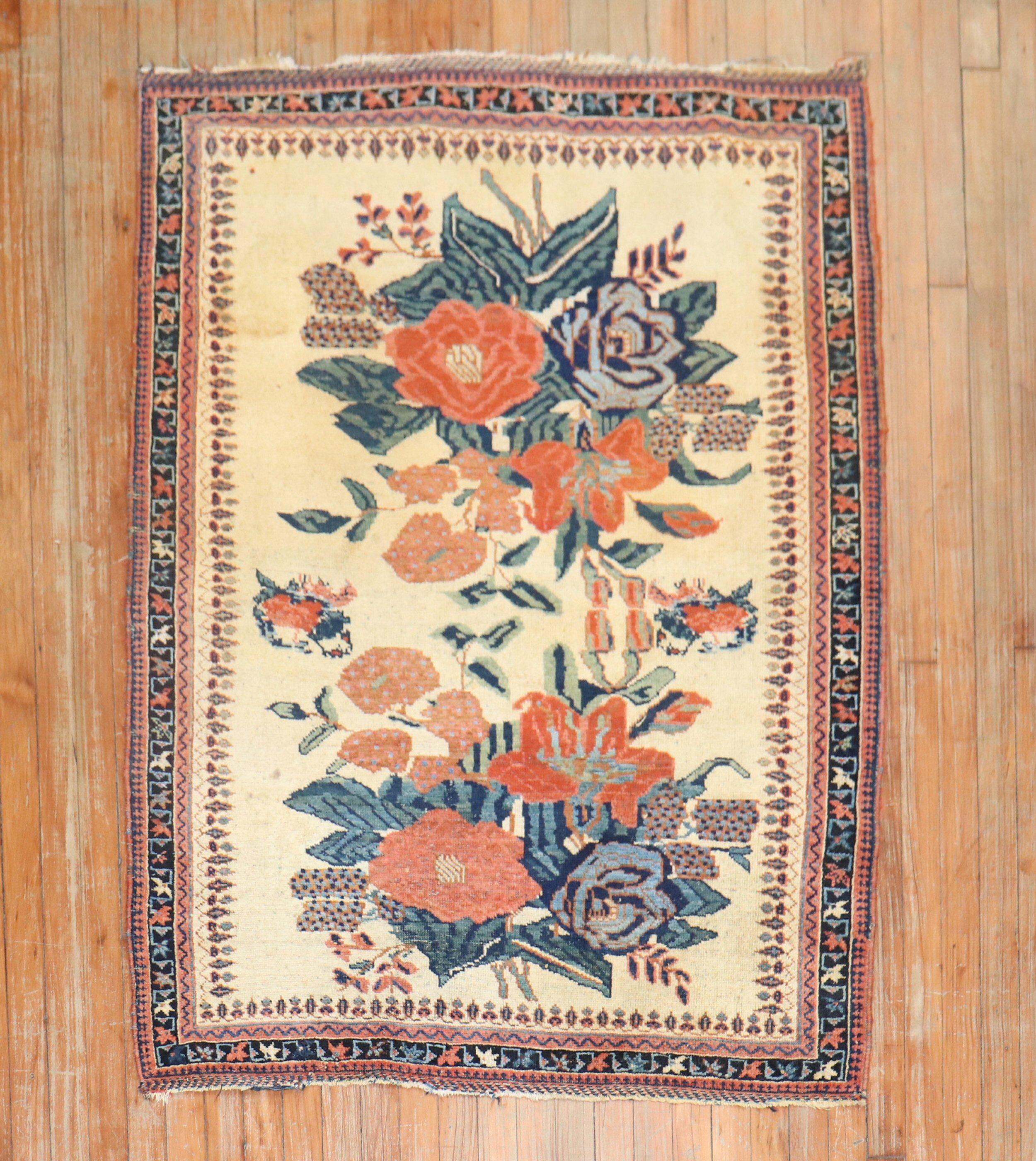An early 20th century Persian Afshar Tribal rug with a large floral design on an ivory field

Measure: 3'9'' x 4'10''.