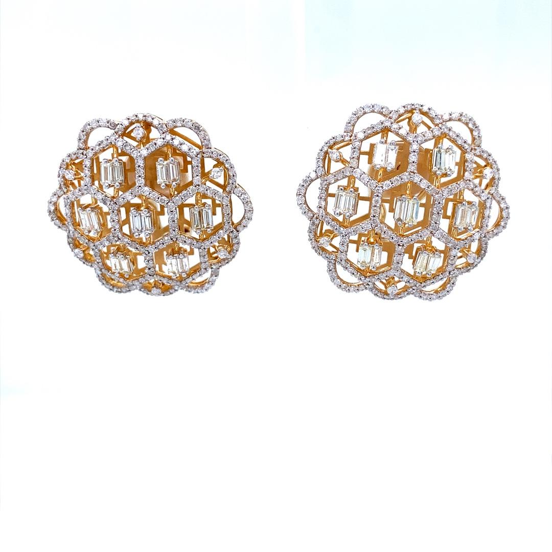 The Floral Stud Earrings with Baguettes & Round Diamonds are a stunning piece of jewelry crafted from 18k solid gold. These earrings feature a floral design with delicate hexagonal patterns adorned with sparkling round diamonds and baguettes at the