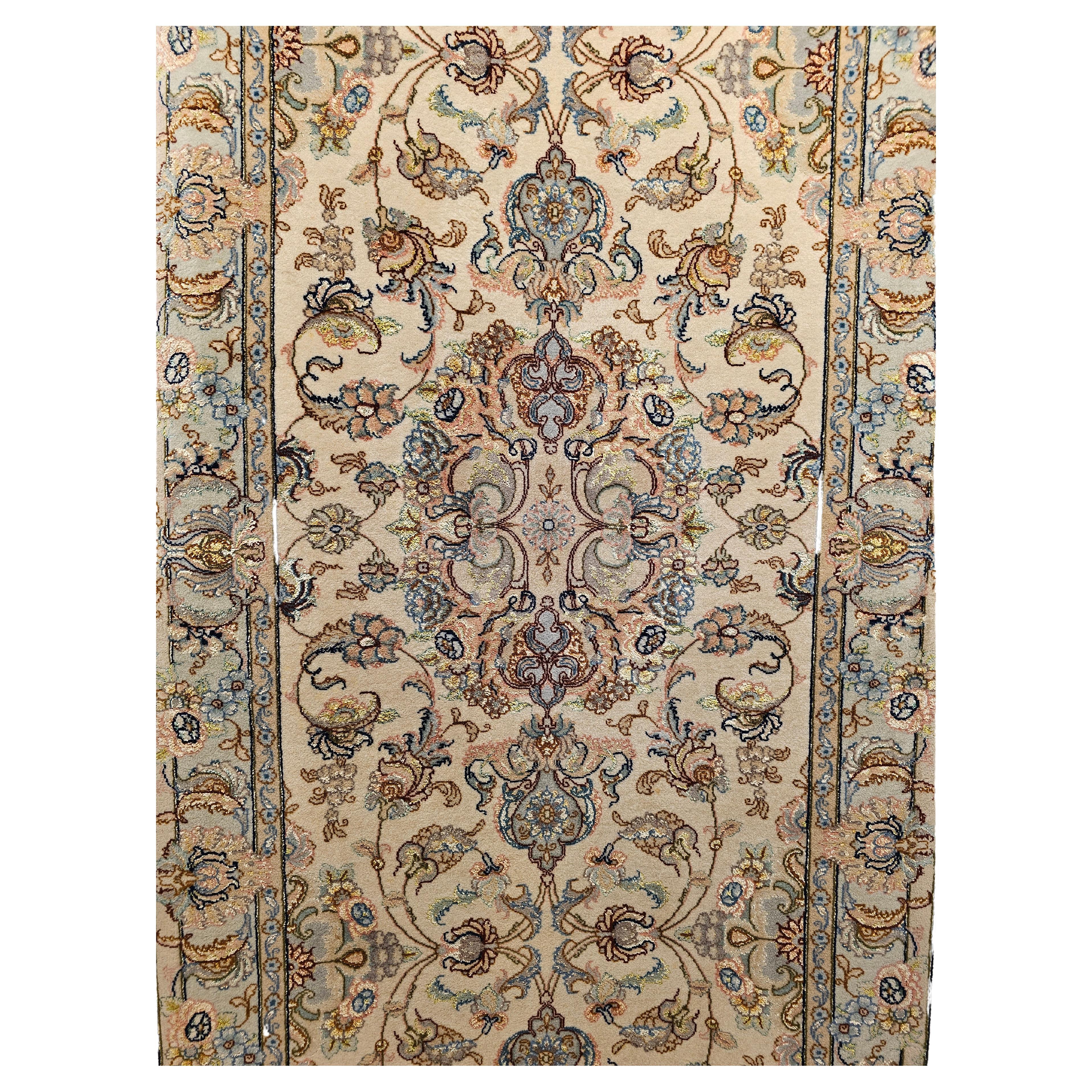 A beautiful and elegant Persian Tabriz runner in a floral pattern with medallions in ivory, pale green with silk highlights from the late 1900s.  The rug has a wool pile with a cotton foundation with extensive use of silk for highlighting.    The