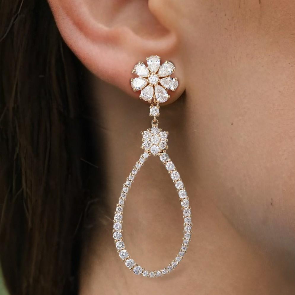 Crafted in 14K gold with natural diamonds, these elegant drop danglers offer timeless beauty. Available in yellow and white gold, they showcase a radiant shine perfect for any occasion. A sophisticated accessory to enhance your style. The sparkling