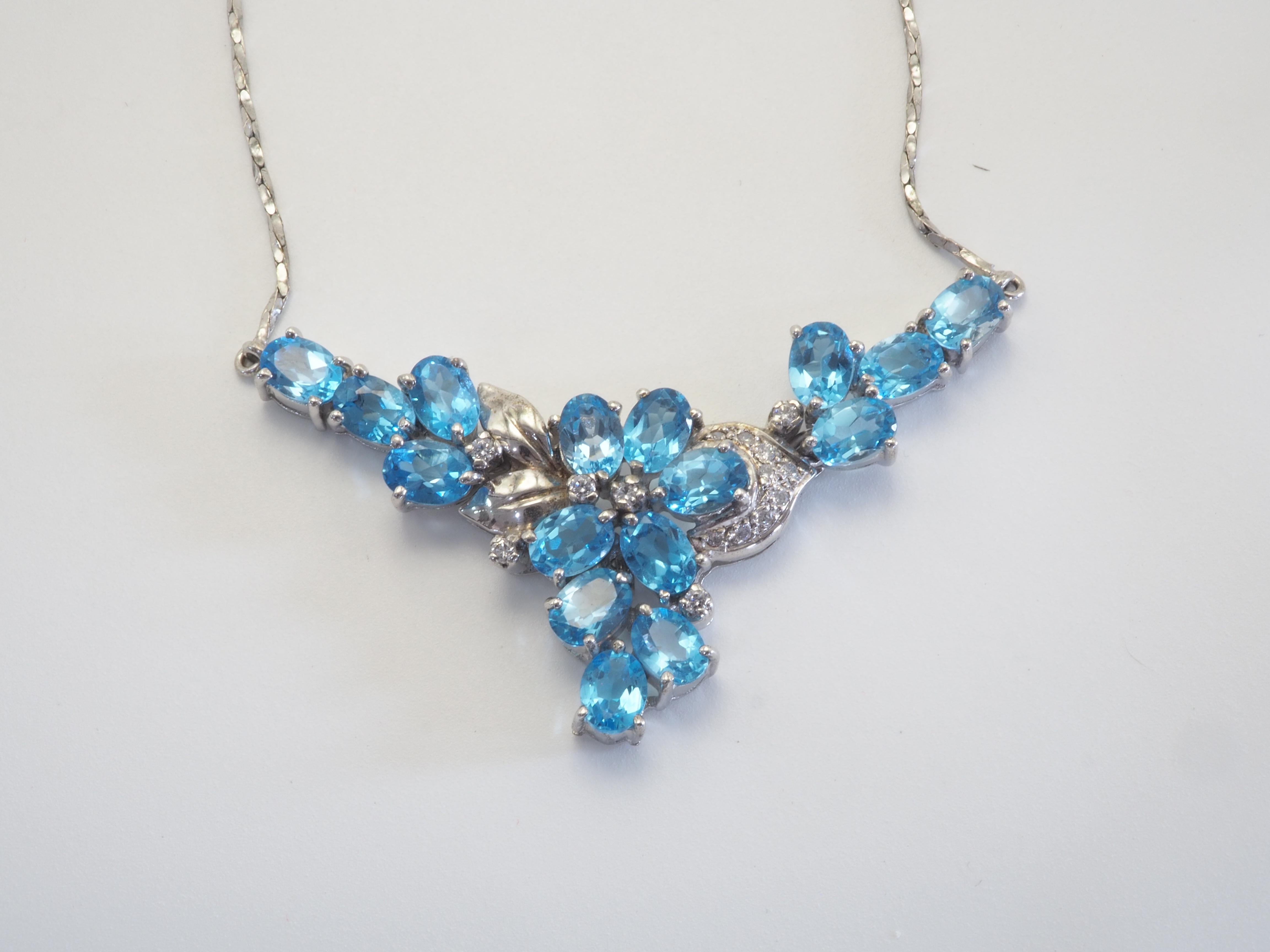 This wonderful piece is a neo- vintage and has never been worn. This beautiful piece is crafted in Thailand using sterling silver metal. The piece is adorned with 16 gorgeous natural oval cut blue topaz and various white quartz inlaid wonderfully.