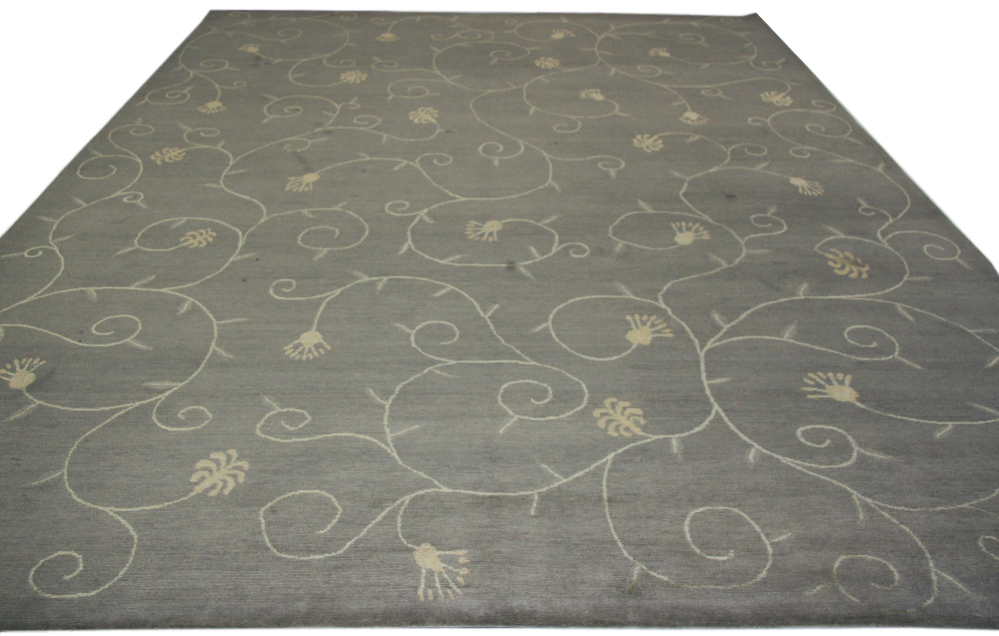 Elegant Tibetan style area rug with whimsical stylized floral scroll.  Hand-knotted in Nepal.  Wool makes the piece both durable and comfortable underfoot.  Taupe/Grey, gold and ivory tones with a 'light' and 'dark' side depending on the angle of
