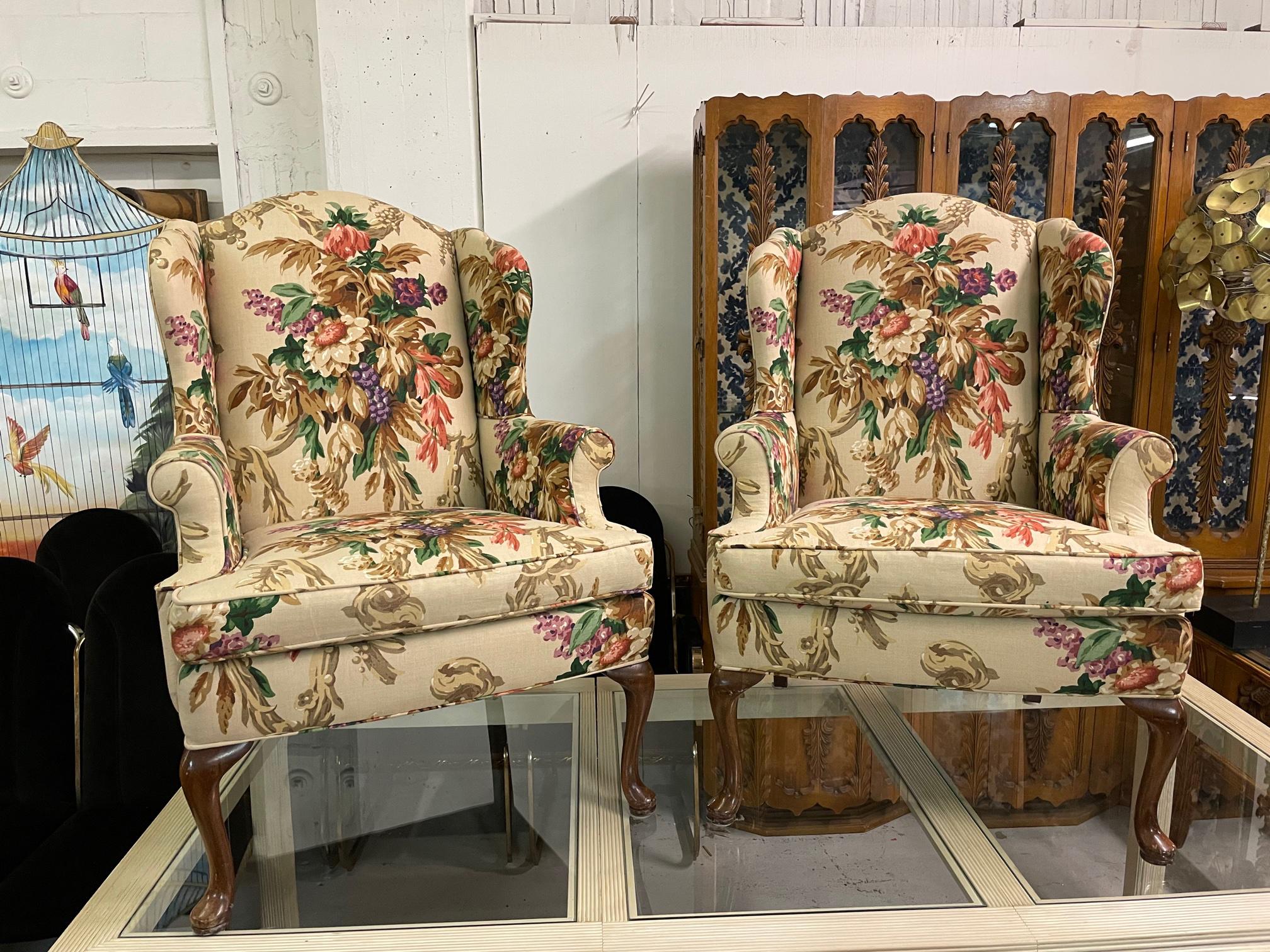 Pair of vintage wingback chairs upholstered in a colorful floral upholstery. Solid construction and only very minor imperfections consistent with age. No odors, stains or holes in fabric.

 