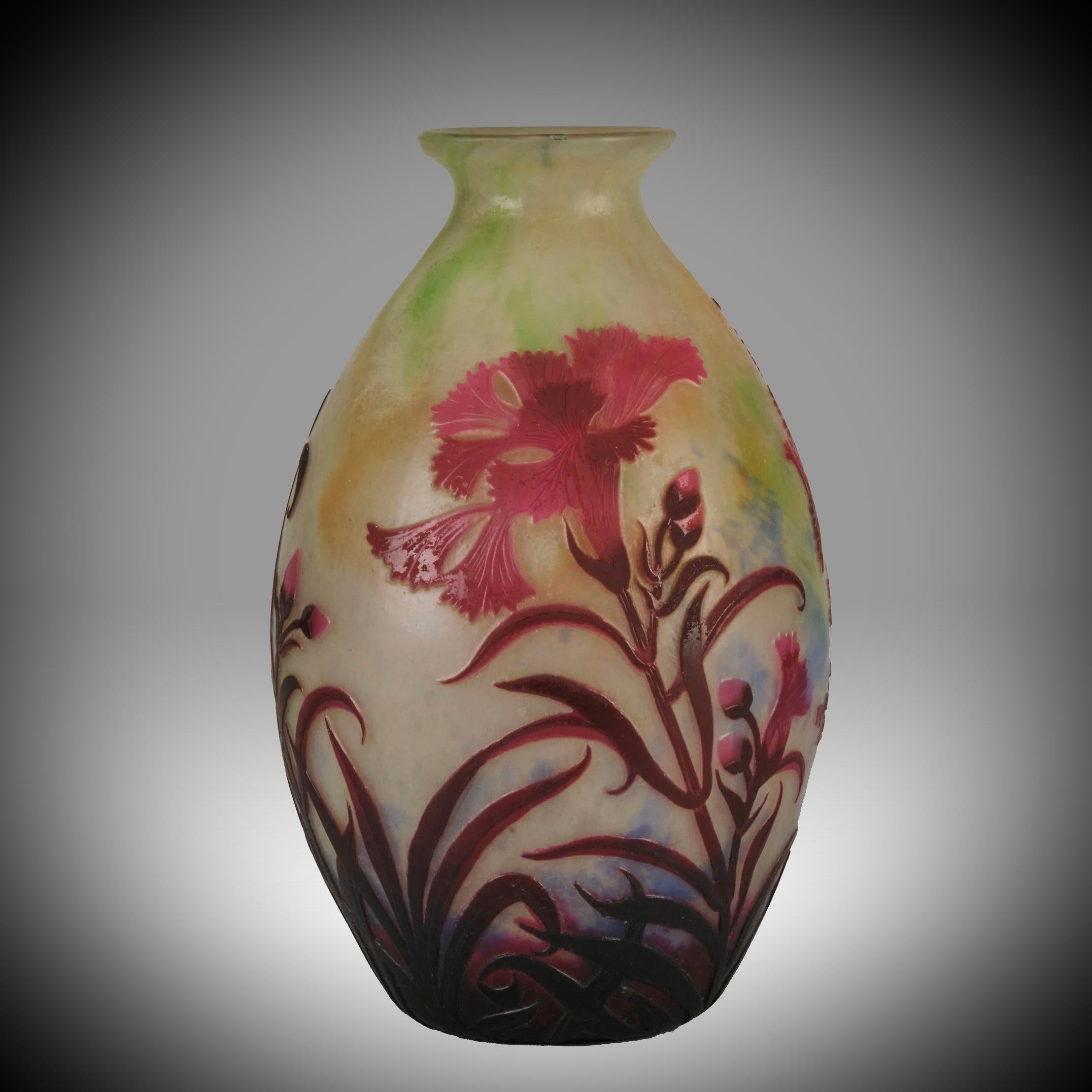 An attractive cameo glass vase acid cut and etched with blossoming red flowers against a cream field with dashes of orange, green and blue. Exhibiting very fine colour and excellent hand chased detail, signed ?Muller Frès Luneville
ADDITIONAL