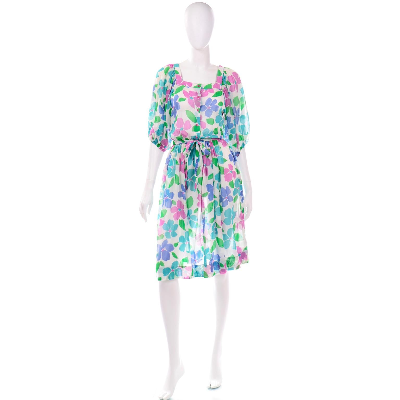 This is a fabulous vintage Albert Nipon Boutique light blue and green floral 3/4 sleeve length dress with waist belt. We love that this dress is so blousy and the sleeves are so voluminous ! Pearl Nipon, Albert's wife, was the designer for the