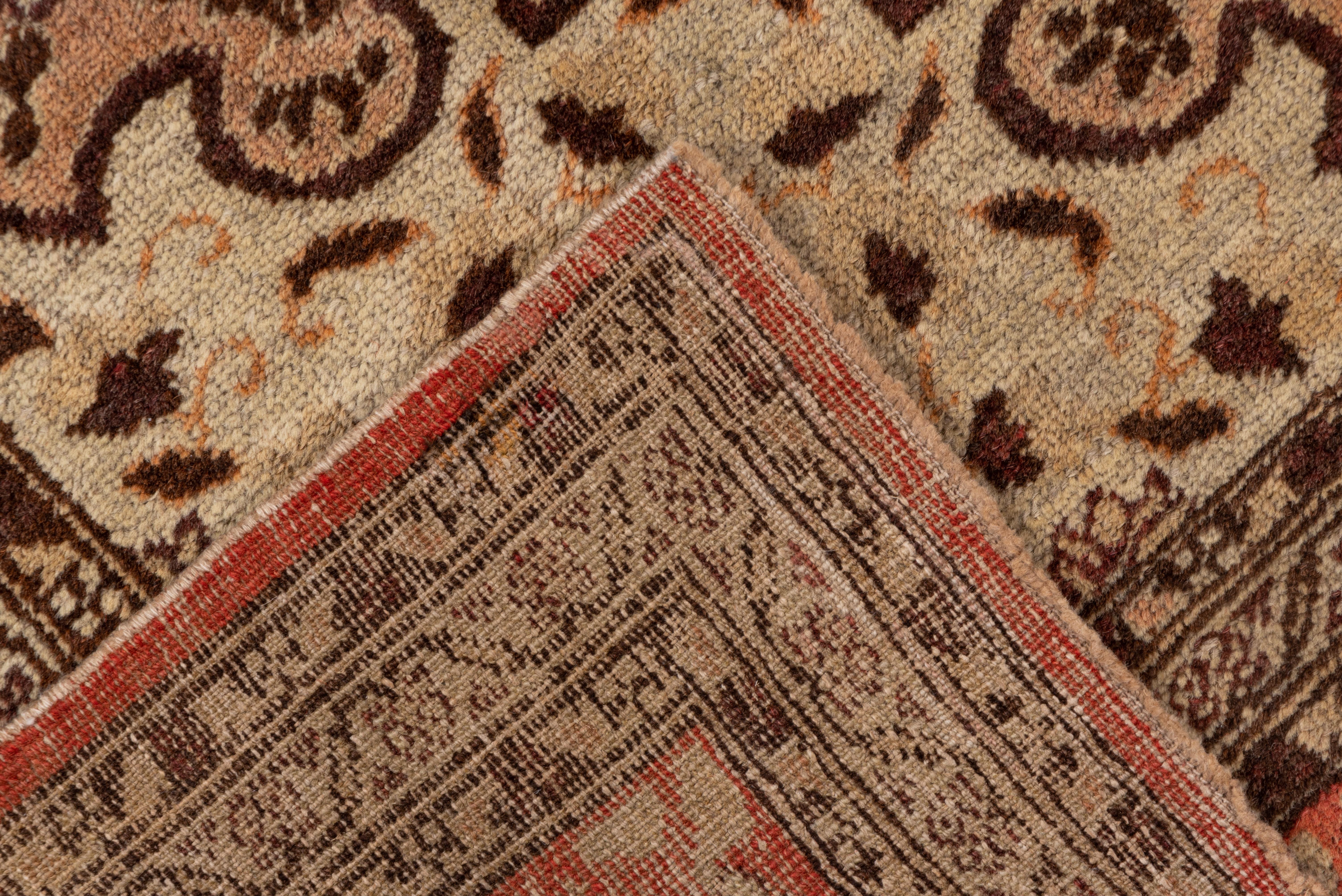 In the Persian Tabriz manner. The light rose field displays a flame edged round eggshell medallion with en suite inner corners, supported by strong leaf and blossom sprays. Light coral border with in-and-out petal palmettes. Medium weave.