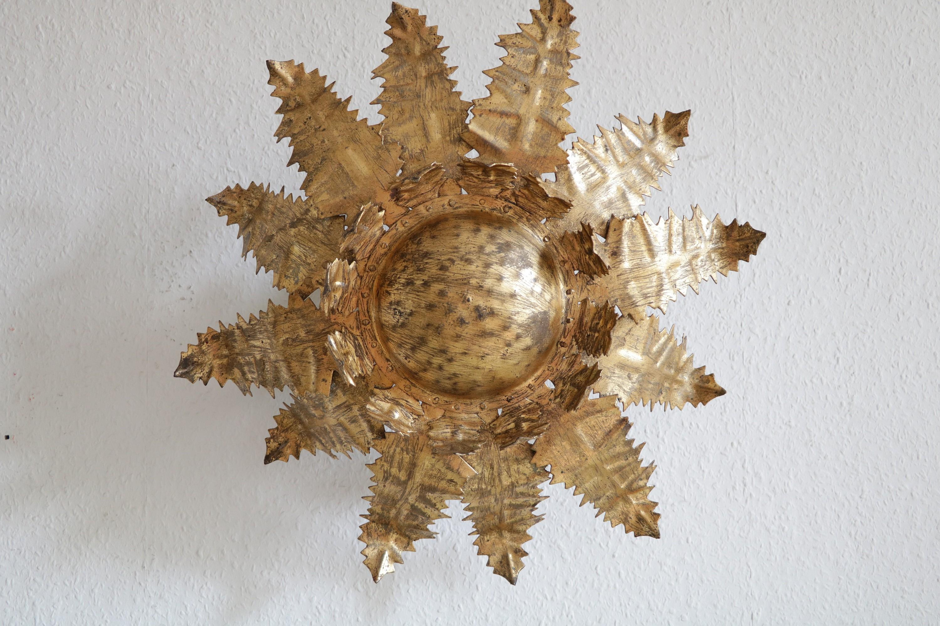 Beautiful wall lamp or flush mount from Italy of the 1950s.
Beautifully handcrafted in metal.
 

Filigree details and brutalist elements at the same time.
6 x E14 sockets on the back, creating a wonderful indirect light.

Diameter: 50 cm /
