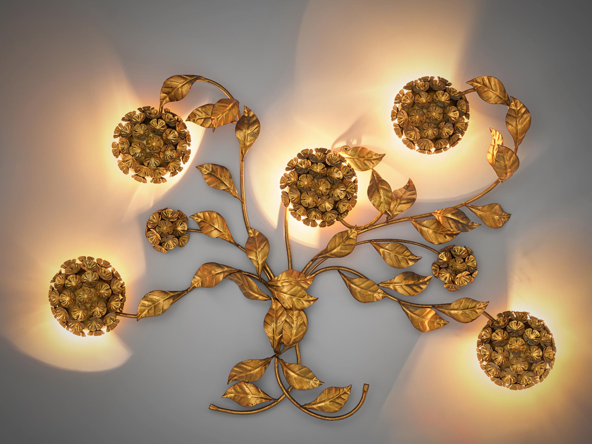 Wall light, brass, European, 1960s

A beautiful large expressive wall ornament with five incorporated lights. The light consists of five leaved branches gathered together in a bunch in the center. The light comes out of the five round flowers in the