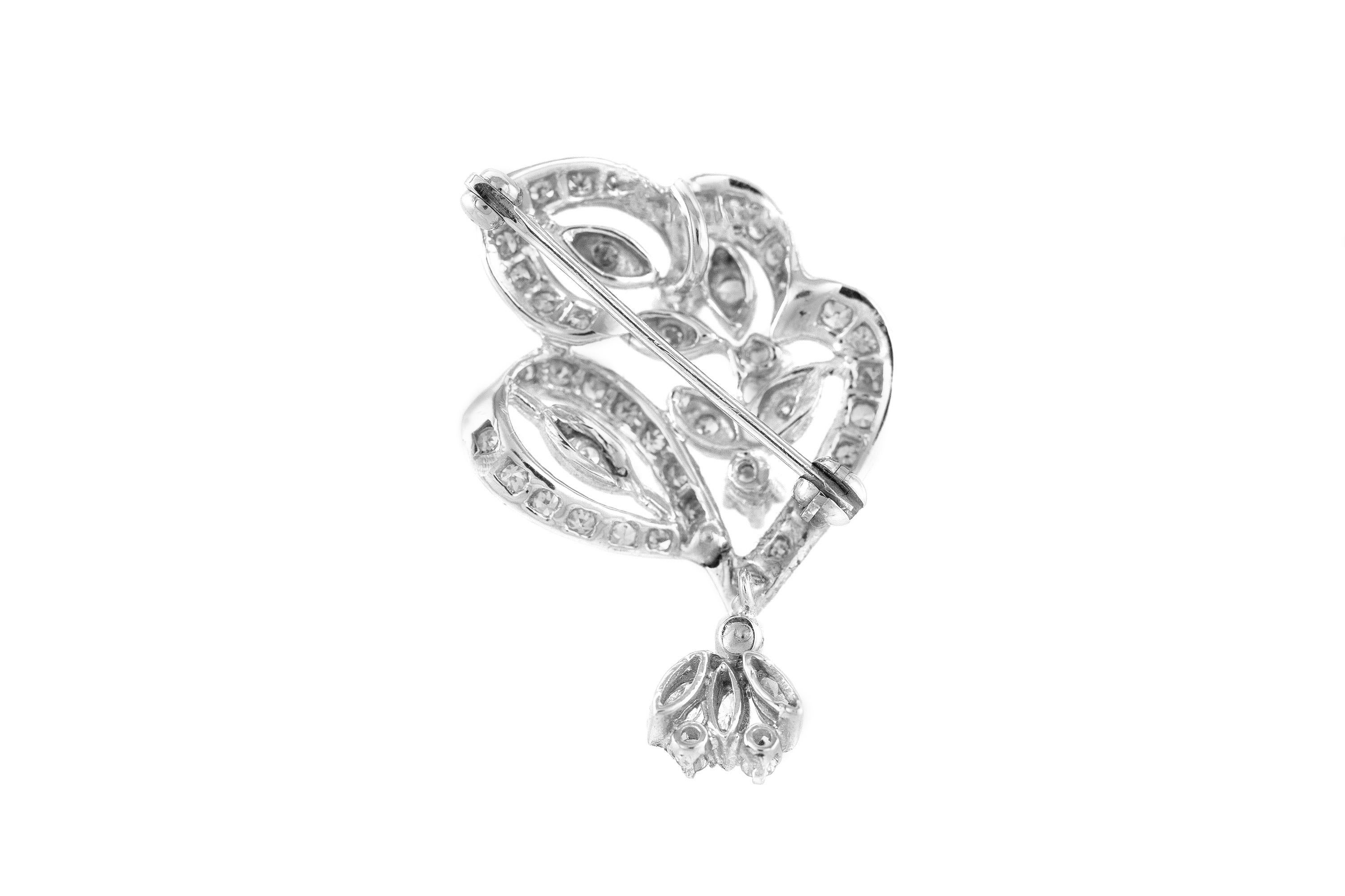 Pendant and a pin finely crafted in 14k white gold, with diamonds weighing a total of 1.30 dwt. Circa 1940.