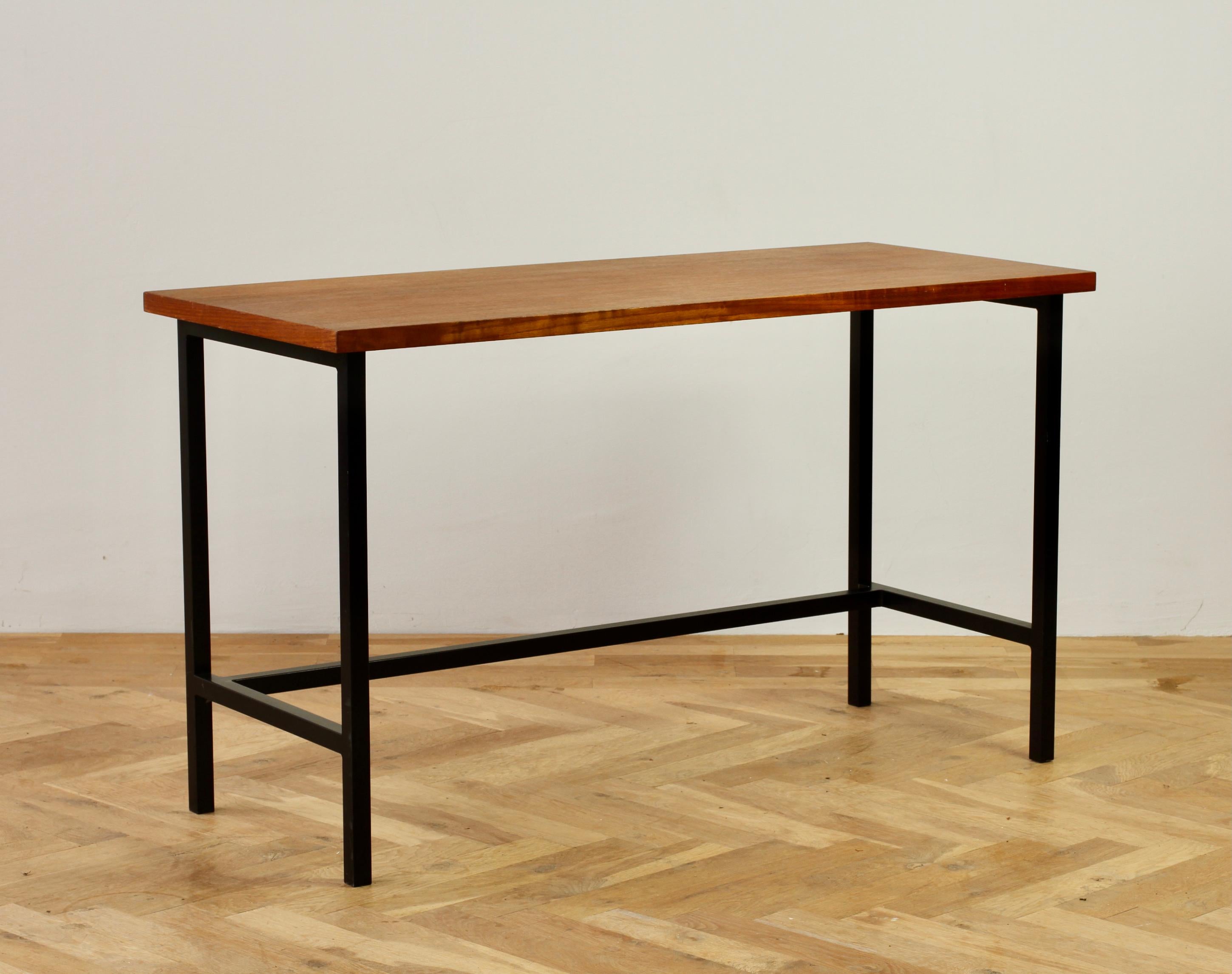 A wonderful modernist American made Mid-Century desk by Florence Knoll, circa 1950s. Made from a black painted square tubular iron frame with a veneered wood (we presume teak). This delightful table, will add warmth and character to any office